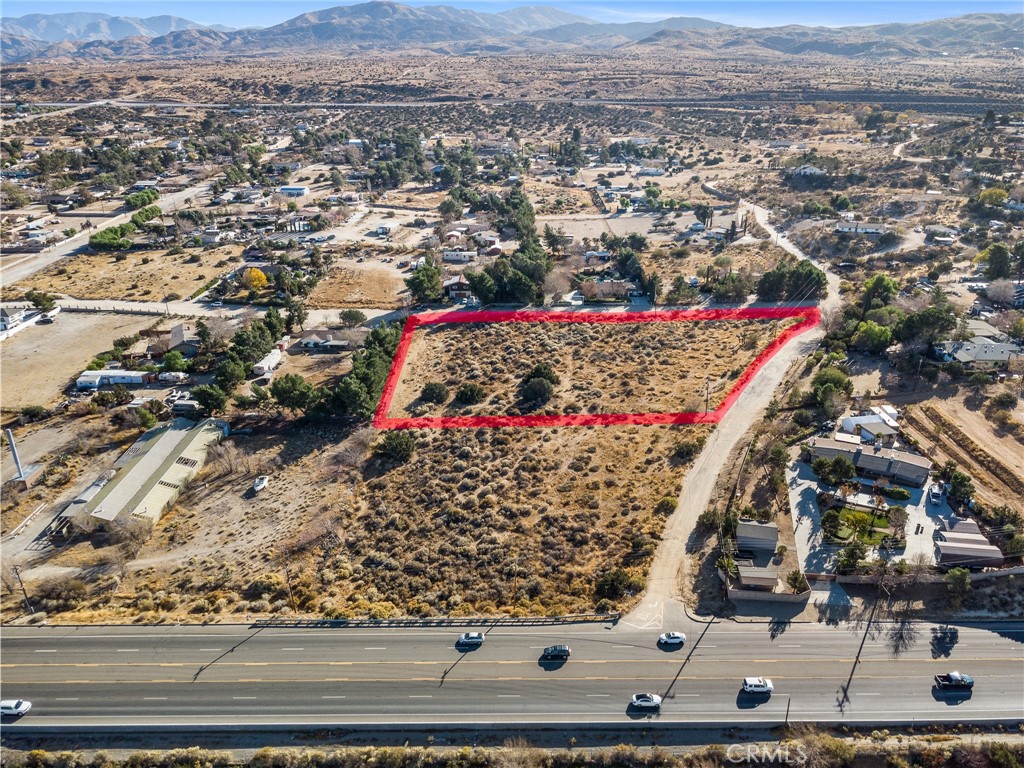Nestled among custom-built homes, this lot provides the perfect blend of rural tranquility and proximity to work, shopping, and schools. Imagine waking up to breathtaking panoramic views, with ample space for your family, horses, and even a thriving garden filled with fresh produce. This spacious lot offers a unique opportunity to build your dream home in the serene Palmdale Hills community. Conveniently located on paved road frontage with water and electricity nearby, this property combines accessibility with the charm of quiet, country living. There are two contiguous parcels being sold separately, 3052-019-010&011. They are located back to back on the corner of Pearblossom Hwy and Valley Spring Rd. Buyer to verify the availability of utilities, water, and development potential with LA County Zoning and Planning. Don't miss this chance to own just under 3 acres of elevated land with unbeatable views along Pearblossom Hwy!
