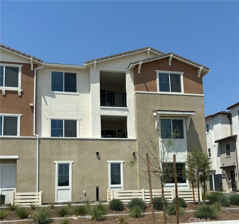 Beautifully designed single-story flat on the 3rd floor. The open floor plan includes a spacious great room that flows into a gourmet kitchen with an island and adjacent dining area. The kitchen features a Stainless steel dishwasher, microwave & refrigerator. The primary bedroom features an en-suite bathroom, a walk-in closet and linen storage. Two additional bedrooms, including one with a walk-in closet, provide ample space for family or guests. Convenient laundry with a stacked washer & dryer. Covered deck, ideal for outdoor entertaining. 2 car Tandem garage with WIFI opener. Private storage room on the same floor. Westport at Eastvale Square amenities include 2 pools, a Fitness Center, BBQ’s, a clubhouse, kids playground & community parks. Conveniently located near shopping & dining. * Blinds are being professionally installed soon.