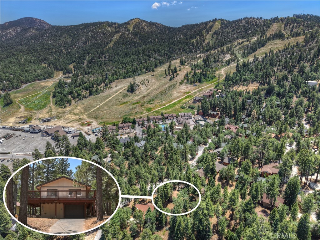 Escape to this well-maintained, custom Chalet-style mountain retreat just two blocks from Bear Mountain Ski Resort! This charming 2-bedroom, 1-bath home offers cozy comfort with a fireplace, gas heating, and a mini-split A/C system. Enjoy peek a boo ski slope views from the expansive wraparound deck, perfect for relaxing after a day on the slopes. The rare 3-car attached garage adds convenience and storage space. Tucked away on a quiet street, with hiking trails just steps away, this property blends adventure and serenity in one beautiful package.