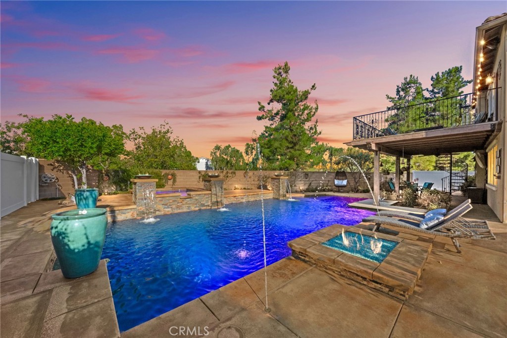 The One You’ve Been Waiting For — Refined Harveston Luxury Living. Welcome to a lifestyle of elegance and ease in the heart of Temecula’s most enchanting neighborhood, Harveston. Tucked away on one of the largest and most private lots in the community, this rare residence is more than a home, it’s an experience. Behind a gated courtyard, discover a tranquil space ideal for morning espresso or evening wine. The detached spacious casita offers exceptional versatility—perfect for overnight guests, a luxe office, or an inspired creative studio. Step inside and be greeted by rich hardwood floors, custom designer details, and a warm, light-filled interior. The chef’s kitchen is the heart of the home, featuring stone countertops, a custom backsplash, new stainless range,appliances, and an expansive island built for both entertaining and everyday indulgence. The primary suite is a true retreat—complete with private balcony access, new quartz countertops, and an expanded spa-style shower. A romantic spiral staircase connects your suite to the showpiece of the home: the resort-inspired backyard. Here, luxury reaches new heights. Enjoy a sparkling pool and spa, cascading fire bowls and water features, a sunken swim up bar area with a built-in fridge and sink. The covered patio with dramatic wood beams that evoke the timeless elegance of Santa Barbara. An outdoor hidden bathroom, multiple lounge areas, a cozy fire pit, and lush garden spaces make this an entertainer’s dream. Best of all? No rear neighbors—just serene open skies. It even has an RV dump. Very rare! Directly across the street, the Harveston Lake Clubhouse offers even more upscale amenities: a junior olympic pool, spa, outdoor fireplace, rolling lawns, and an 18-acre lake surrounded by charming tree-lined streets and vintage-style lampposts. Located just minutes from Temecula’s award-winning wineries, top-rated schools, fine dining, and freeway access. This extraordinary home offers the perfect blend of luxury, comfort, and lifestyle. This is not just a home. This is a statement. This is your sanctuary. This is Temecula.