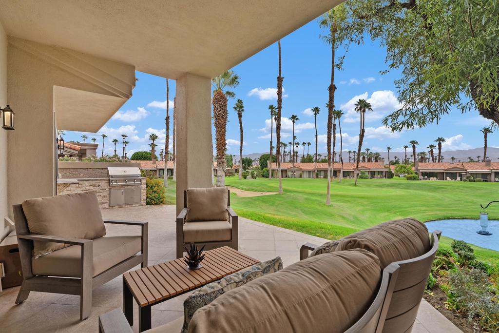 One of the premier locations in Palm Valley Country Club. This beautifully remodeled Sycamore Plan offers stylish desert living with AMAZING views! The patio captures stunning views of the #1 Challenge Course green and sparkling lakes; the perfect backdrop for morning coffee or evening gatherings. A gourmet kitchen features granite counters, stainless steel appliances, custom cabinetry, and an island/breakfast bar with accent lighting. The spacious living room boasts a stacked stone fireplace with inset flat screen TV and a wet bar. A versatile den (or 3rd bedroom) highlights built-in cabinetry, stacked stone accents, and its own flat screen TV. The reimagined primary suite includes abundant closet space, dual sinks, a walk-in shower, and private courtyard retreat. Designer finishes, granite, and cabinetry flow seamlessly throughout the home. Recent upgrades include: Outdoor kitchen, new water heater, refrigerator, garage door opener, AC/Furnace with new ductwork and insulation, windows and patio doors, and washer and dryer. Palm Valley CC offers world-class amenities: two Ted Robinson golf courses, 46 pools and spas, tennis and pickleball, a state-of-the-art fitness center, with an additional pool and spa, as well as salon, spa with treatment rooms, plus multiple dining and social venues.