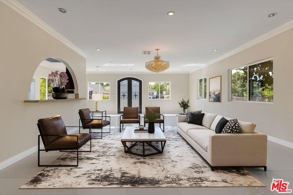 Welcome to a home bursting with life! Behind a private gate, on a beautiful street in one of Encino's most coveted neighborhoods, this move-in ready home offers an unexpected blend of comfort, nature, and soul. Inside, sunlight filters through generous windows, warming newly updated floors and clean, open living spaces. The kitchen is built to be used and loved -- with stainless steel appliances, thoughtful design, and exits to the lush backyard beyond. A large grassy yard, multiple mature fruit trees, a thriving grapevine, and even a chicken coop that adds a touch of rustic charm. Each bedroom and bathroom has been thoughtfully designed with ample closet space, high ceilings, and separate laundry room. While the home is located minutes from the best of Ventura Boulevard, it feels worlds away -- an ideal hideaway for anyone who appreciates both serenity and convenience. Encino living means beautiful mornings, golden light through the trees, and quick access to everything from upscale groceries to hidden sushi spots. This property captures that balance beautifully: private, grounded, and full of character...