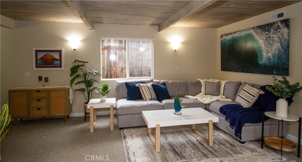 Nestled in the scenic town of Los Osos, this unique property offers the perfect blend of cozy charm and modern versatility. The main level features a 2-bedroom, 1-bath home with 833 square feet of living space, complete with its own laundry area and charming wood ceilings that evoke the feel of a cozy cabin. New carpet throughout both levels adds a fresh touch to this inviting space. Above, you'll find a, permitted 1,164 square foot executive studio with a private entrance. This upper-level retreat includes a spacious kitchen, laundry area, walk in closet, 3/4 bathroom, and a viewing deck where you can take in the views of the surrounding area. Whether you’re seeking additional living space for family, guests, or even rental income, this studio offers endless possibilities. Outside, the property features a fenced yard with a patio area, great for relaxing or entertaining. A storage shed in the backyard provides additional space for tools, equipment, or other storage needs. For added convenience, a carport offers covered parking for two cars side by side. Perfectly situated, this home is less than a block away from Baywood Elementary School, a dual-immersion school, and only a few blocks from downtown Baywood, which sits on the beautiful bay. Enjoy bird watching by the bay, kayaking, or taking a stroll along the water’s edge. You can also savor breathtaking sunsets over the dunes. With popular eateries, a Monday farmers market, and more just minutes away, this location offers the best of both convenience and natural beauty. Whether you're looking for a cozy home or a property with potential for extra income, this charming residence in Los Osos is a true gem.