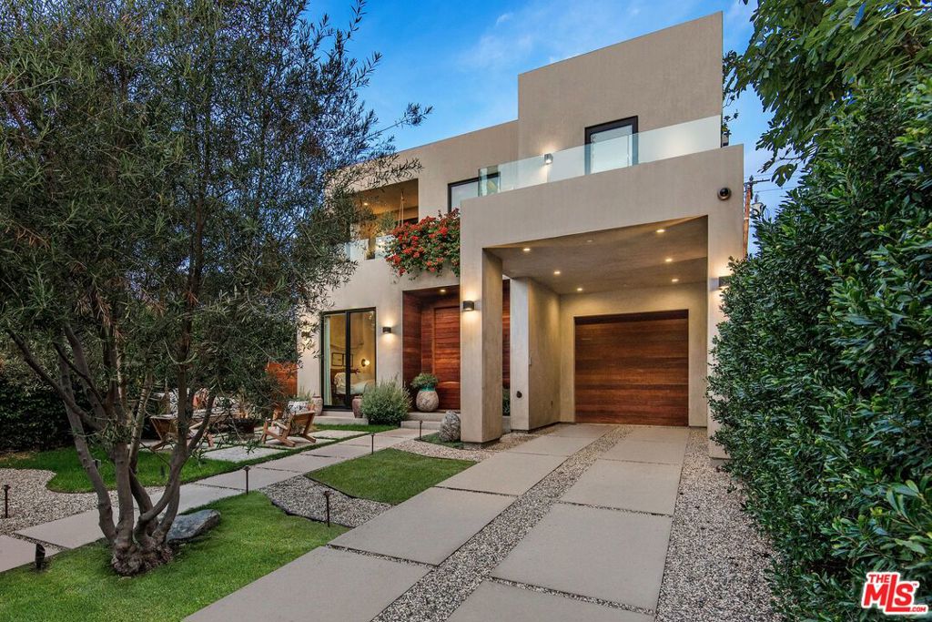 Set behind private gates, this exceptional residence is defined by its expansive outdoor terraces and mature, lush landscaping. Offering approximately 3,500 square feet of seamless indoor-outdoor living, the home is designed for both relaxation and entertaining. Open-concept interiors feature three bedrooms, an office, and three baths, along with a chef's kitchen showcasing Italian cabinetry, a custom island, walk-in pantry, and Gaggenau appliances. Walls of fleetwood glass doors open to expansive terraces, a sparkling pool with spa and water feature, and serene lounge areas surrounded by greenery and lush potted plants for ultimate privacy. Additional features include lutron lighting system, security cameras, door bird entry, outdoor heaters, motorized driveway gate and built in and outdoor speakers, and a one-car garage with additional three parking spaces behind gates. Located steps from some the hottest restaurants and shopping in all of Los Angeles, this home offers a harmonious blend of modern design, luxurious amenities, and a prime location. It is a true masterpiece that exemplifies contemporary living at its finest.