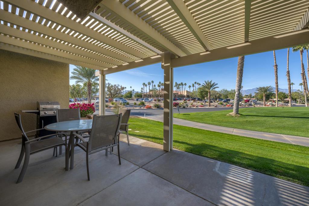 This highly sought-after Vintage floor plan is available & ready for you! This exquisite 2/2 unit features a well-designed split master layout w/great open room concept. Upon entry, you'll be greeted by elegant vinyl wood flooring throughout and an abundance of natural light. The updated kitchen offers generous storage with large pull-out drawers, updated cabinetry, stainless steel appliances, granite slab countertops with a matching backsplash, and a breakfast bar. The great room is highlighted by vaulted ceilings, mid-century modern style decor, a sliding door leading to the rear patio, and seamless connectivity to the kitchen, creating an ideal space for entertaining. The primary bedroom includes a walk-in closet with a barn door, owner's closet, a sliding door to the rear patio, and a private en-suite bath. Both bathrooms have been thoughtfully updated with contemporary cabinetry and granite slab counters. The guest bedroom also features a sliding door to the patio and a walk-in closet. Step outside from the great room to the extended rear patio, where you can enjoy stunning views of the golf course and mountains. This turn-key furnished unit is ideally situated just across from the clubhouse, practice range, and pool/spa. As a resident, you'll have access to a wide range of amenities like pickleball, tennis courts, golf, bocce ball, clubhouse dining and bar, cafe, pro shop, and 20+pools/spas. Short-term rentals ok - providing an excellent opportunity for added income!