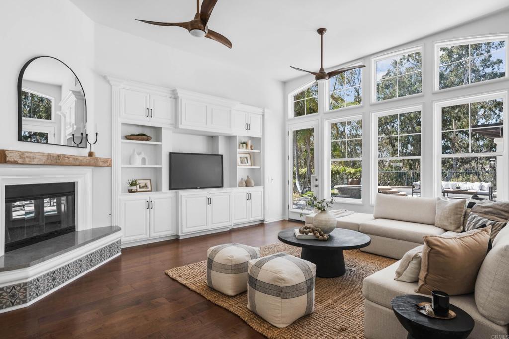 Nestled in the desirable “Mar Fiore” Aviara community, this single-story home backs to open space with lush greenery and serene views. A grand rotunda entry with soaring ceilings welcomes you into a sprawling floor plan with rich wood and beveled Versailles-patterned tile flooring, elegant arches, and freshly painted walls. The expansive living and dining room combination boasts exposed wood-beam ceilings and French doors. Work from home in the sophisticated office featuring built-ins, crown molding, and wainscoting. The gourmet kitchen offers custom cabinetry, a large center island, and stainless-steel appliances, flowing to a breakfast nook and family room with fireplace and built-in media wall. The primary suite includes a fireplace, open shelving, generous sitting area, and a luxurious spa bath with dual vanities, soaking tub, oversized shower, and custom closet system. Private, resort-style backyard features a sparkling pool and spa, fireplace, and covered dining with built-in BBQ. Additional amenities include spacious secondary bedrooms, laundry with sink, whole-house fan, A/C, solar tubes, and a three-car garage with storage. Minutes to beaches, shopping, trails, golf, and luxury resorts, this home delivers the ultimate coastal lifestyle. Award-winning schools include Aviara Oaks Elementary and Middle and Carlsbad High. Low HOA of $133 per month and Mello-Roos of just $79 per year. Buyer and buyer’s agent to verify all in MLS prior to COE.