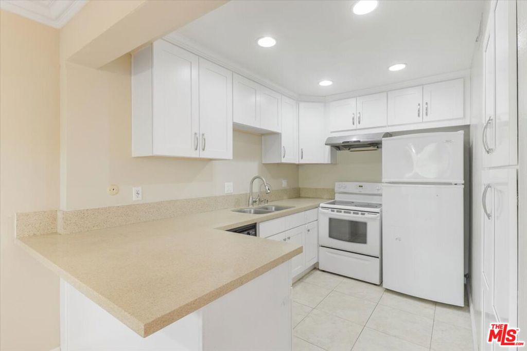 This perfectly-laid-out condo checks all the boxes Unit is secluded in the rear to maximize peace and quiet without compromising light and bright sun upstairs with great views of rooftops and the San Gabriel mountains. Parking is in your own 2-car garage just a few feet from your own unit's front gate. Unit's entrance includes a private patio ready for morning coffees or evening barbecues. Once inside, you will find a bright, open floor plan with a breakfast bar, recessed lighting, crown molding, and a gas fireplace. Talk about storage, the kitchen has ample cabinetry, as well as a bonus wall pantry, the living room has an ample closet as well as a bonus "secret" floor-level storage cove, and the garage has a full wall of built-in shelving. Laundry is not just in-unit, it's literally upstairs, just steps from the two bedrooms. And speaking of the bedrooms, wait until you see the beautiful wooden beams that make up the vaulted ceiling in the Primary bedroom. This condo's perfect layout makes it feel and function like a much larger home. The condo features brand new interior paint with older but highly functional kitchen and bath upgrades. Cold A/C keeps you comfortable and insulated from the outside elements. Complex features a swimming pool and well-kept landscaping. No smoking/No pets. Priced to move quickly, make plans today to come visit this property asap!