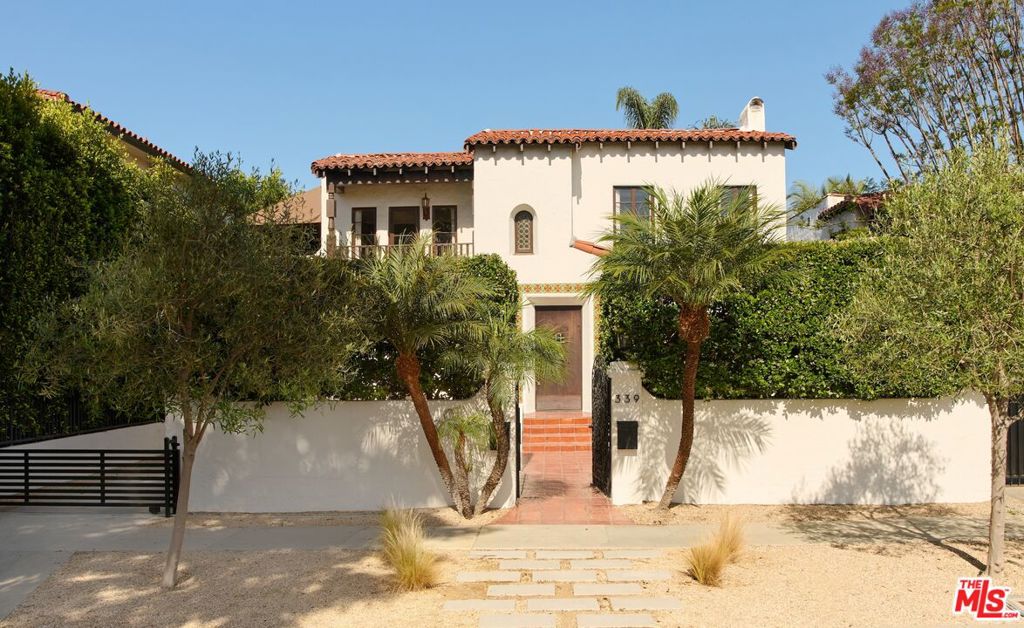 Discreetly tucked away in the heart of West Hollywood, this exquisitely appointed 1929 Spanish upstairs/downstairs duplex whispers of old-world romance and artistic possibility. Beyond its gated entrance, a lush, secluded courtyard invites you to wander beneath the dappled light, an intimate prelude to the magic that awaits within. Inside, a dramatic foyer with original tiled stairs and a glowing stained glass window you'll find separate, private entries to each residence. Both upstairs and downstairs spaces offer a 3-bedroom, 2-bathroom floor plan, each brimming with soulful character, beamed ceilings, arched doorways, updated kitchens and baths, a grand fireplace, and hand-carved wood doors that speak to the craftsmanship of another era. The gardens, reimagined by ORCA with native specimens, unfold like a love letter to LA's natural beauty. A large detached garage has been converted into a studio or flex space, perfect for creative pursuits. A long, gated driveway completes the picture, offering privacy and ease. With a prime location that offers easy proximity to Melrose Place and all that WeHo offers, this rare sanctuary is more than a home, it's a feeling.