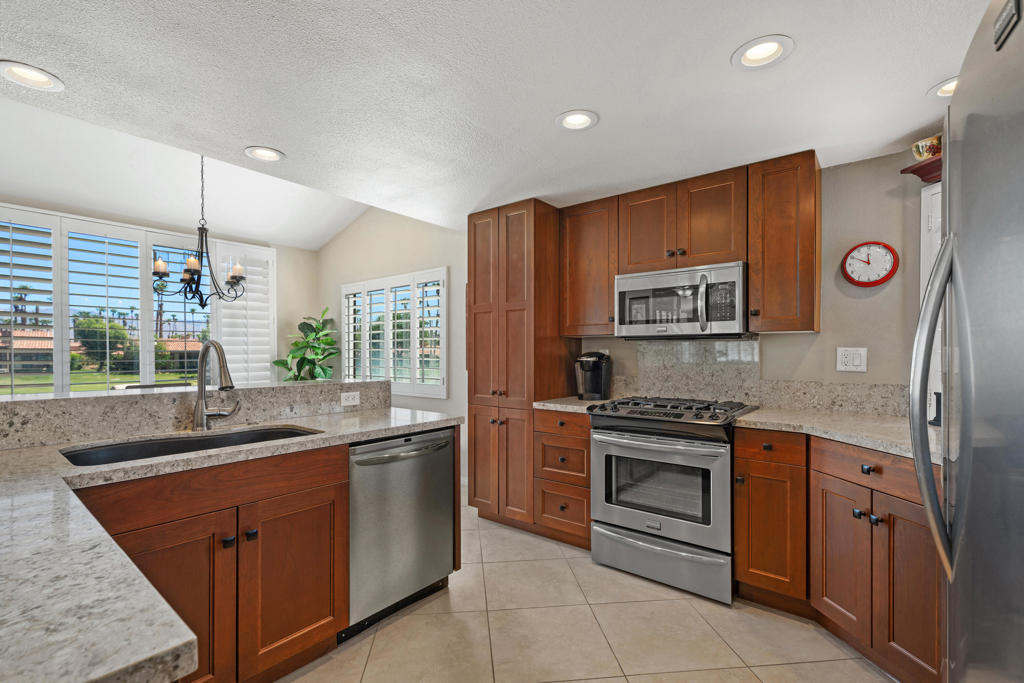 Welcome to 76662 Daffodil Drive, a fully renovated 3BD/3BA Cottonwood model in the sought-after Palm Valley Country Club. With 1,627 sq ft of stylish living space, this home is perched on the 18th fairway of the Championship Course, offering panoramic golf course and Chocolate Mountain views. The open-concept great room unites the kitchen, dining, and living areas with contemporary finishes, plantation shutters, and a cozy fireplace--all designed for seamless indoor-outdoor living. The remodeled kitchen features shaker cabinetry, stone counters, stainless appliances, and designer lighting. Lots of light from being a corner unit.Step outside to an extended tiled patio--ideal for entertaining or unwinding after a day on the course. The spacious primary suite opens to a private courtyard and boasts dual vanities, updated bath, and generous closet space. Offered turnkey furnished, including a golf cart, and just steps from the community pool--it feels like your own!Located on fee land with short-term rental approval, this home is perfect for full-time living, seasonal escapes, or investment. Enjoy 46 community pools/spas, 36 holes of Ted Robinson-designed golf, tennis, pickleball, fitness center, luxury spa, dining, and an active social club. Live the ultimate desert lifestyle!