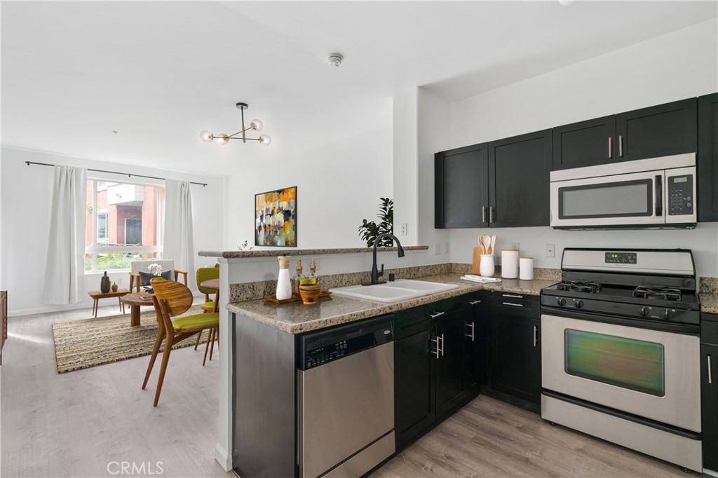 Nestled in the heart of Little Tokyo and the vibrant Arts District, this delightful one-bedroom, one-bathroom condo offers a unique blend of city living with resort-style amenities. The unit spans 735 square feet of thoughtfully designed living space. As you step through the front door, you're immediately greeted by an open concept living room, dining area, and kitchen. The kitchen is well-equipped with ample counter space and modern appliances. Adjacent to it is the spacious dining area that easily accommodates a sizable table for hosting dinner parties or enjoying meals at home. The living room is airy and bright, leading out onto a private balcony where you can enjoy views of the community courtyard. The tranquility of this outdoor space makes it an ideal spot for morning coffee or winding down in the evening. Unit 213's location on the second floor ensures peace and quiet away from street noise. The inclusion of an in-unit side-by-side washer and dryer adds convenience to everyday chores. Living in the esteemed SAVOY Community comes with access to numerous amenities aimed at enhancing your lifestyle. These include landscaped courtyards, a pool and spa and fitness center. Entertain friends at the Sports Cafe clubhouse or BBQ grills or indulge in a movie night at the screening room. For those working from home, take advantage of the business center equipped with a library and conference room. The rooftop deck showcases breathtaking skyline views which residents can enjoy anytime they please. Beyond SAVOY’s gates lies Little Tokyo and Arts District offering cultural experiences like art galleries, museums as well as proximity to some of LA's most renowned restaurants all within walking distance. Unit 213 at 100 S Alameda St offers a balanced lifestyle of comfort, convenience, and city living. Whether you're enjoying the luxury amenities within the community or exploring the vibrant surroundings, this property is truly a gem in the heart of Los Angeles.