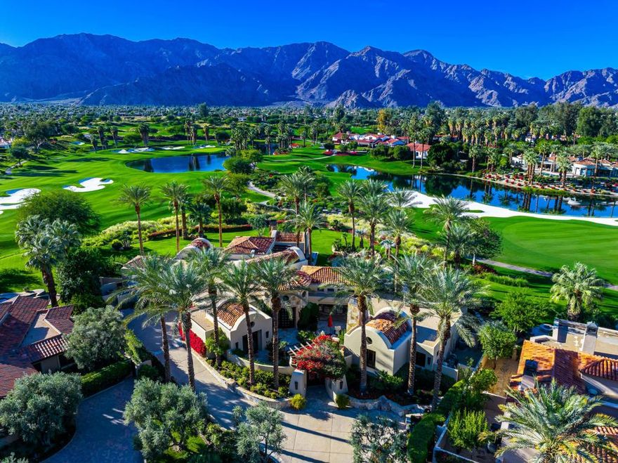 Spectacular custom estate at the exclusive Tradition Golf Club in La Quinta. Situated on a prime, nearly one acre lot at the end of a cul-de-sac, with panoramic golf course, mountain and lake views, on the 1st fairway of the renowned Arnold Palmer course! The open floorplan features four bedrooms, four baths + powder room, with a bonus game room (that could be a 5th bedroom) plus an office, in a spacious 6,439 SF. This thoughtfully appointed home was meticulously designed by Gordon Stein, showcasing our enviable indoor-outdoor desert lifestyle! Interiors by Fedderly and Associates feature a great room which boasts pocket doors, travertine flooring and soaring wood ceilings. The generous chef's kitchen opens to all living areas, is appointed with top-of-the-line appliances and finishes. The elegant primary suite has a fireplace, oversized spa-like bath, and a gym (that  can be converted to another closet). As you proceed outside, there is an outdoor living room with fireplace and TV, a custom grilling station plus a custom designed pool and spa with waterfalls, beautiful landscaping and jaw dropping views! Completing this exceptional property is a three car + two golf cart garage. Offered furnished. This is a must-see offering that artfully combines luxury and total privacy!