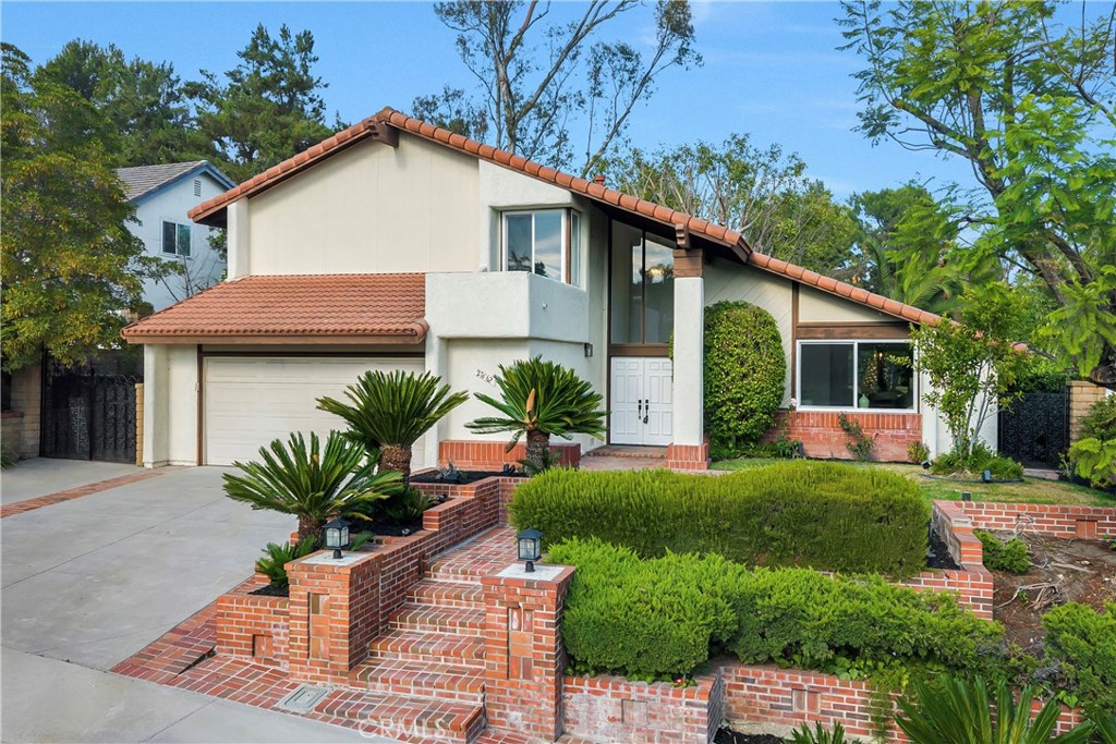 Welcome to 27662 ESLA, a BEAUTIFULLY REMODELED HOME in the prestigious MADRID DEL LAGO community in the heart of MISSION VIEJO—an area known for its charm, serenity, and high demand. From the moment you enter, you’re welcomed by SOARING CEILINGS, ABUNDANT NATURAL LIGHT, and a thoughtfully designed OPEN LAYOUT that feels both spacious and inviting. The entire home has been tastefully upgraded, featuring BRAND-NEW WINDOWS THROUGHOUT, ELEGANT NEW FLOORING, and a CHEF’S KITCHEN complete with WARM OAK CABINETRY, SLEEK WHITE GRANITE COUNTERTOPS, and PREMIUM STAINLESS STEEL APPLIANCES. A COZY INDOOR FIREPLACE anchors the living space, and a GIANT FOLDING DOOR opens wide to the backyard, creating the ultimate INDOOR-OUTDOOR LIFESTYLE. Whether entertaining or enjoying a quiet evening, the BEAUTIFULLY LANDSCAPED BACKYARD offers PRIVACY, SERENITY, AND SPACE—plus a LARGE SIDE YARD WITH POTENTIAL RV PARKING. Upstairs, the generous PRIMARY SUITE features PEACEFUL VIEWS, a SPACIOUS LAYOUT, and AMPLE CLOSET SPACE. All bathrooms have been FULLY RENOVATED WITH HIGH-END FINISHES AND THOUGHTFUL DESIGN. Additional highlights include a GARAGE WITH AN EPOXY-COATED FLOOR, adding both durability and a clean, finished look to your storage or workspace.vPerfectly situated on A QUIET, WELL-KEPT STREET, this home truly stands out as one of the most desirable properties in the Madrid Del Lago community. You also have ACCESS TO LAKE MISSION VIEJO AMENITIES, including access to the lake, picnic areas, beach, fireworks, concerts, and more.