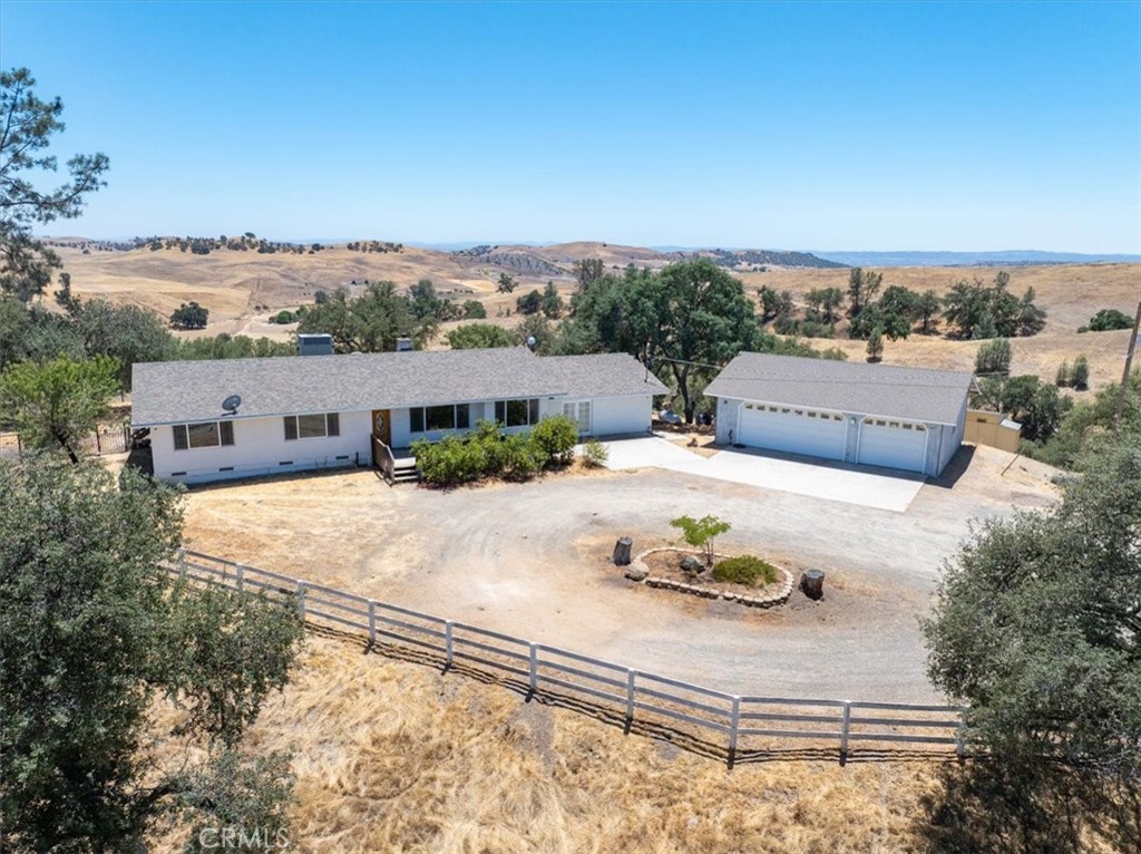 Private and peaceful country living await you on this beautiful 60 acre parcel! You'll love the 2000+/- sq. ft home with three bedrooms and two baths. In addition to the living room and family room there is a bonus room, possible office space and laundry room. Next to the home is a detached three car garage and there is an additional shop building for storage or the hobbies of your choice. But wait, there's more! There is cute, newer incomplete structure that could possibly be used as an ADU or for storage. The land is a combination of open rolling grazing ground with the compliment of native oaks and pines around the home and down the hillsides. The views are gorgeous, the land would be excellent for horses and cattle. There's plenty of usable ground for additional improvements too! Lots and lots of possibilities here!