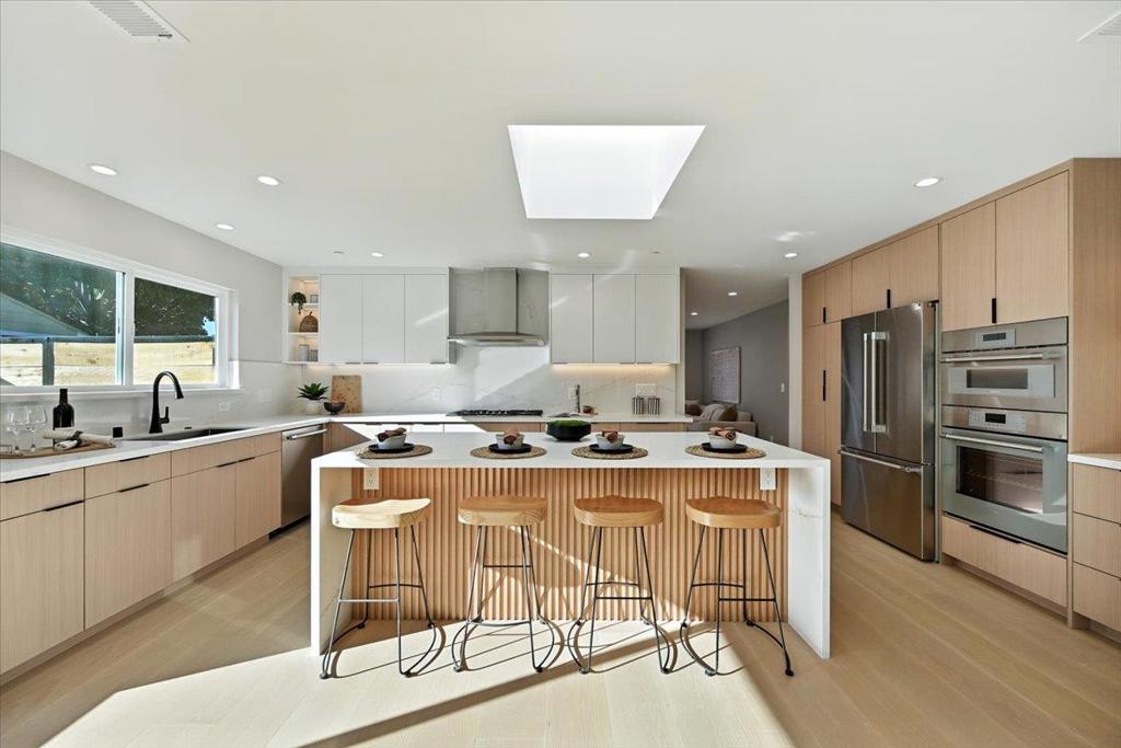 Suffused with Zen-inspired design and beautifully-lit spaces, this home has been completely renovated to the studs into the spa-like haven of your imagination, complete with uncompromising quality and exquisite design details throughout. The kitchen's waterfall island, customized cabinetry, and high-end appliances bathe in ample natural light that cascades from a central skylight, while a recessed ceiling reflects light to augment key decorative features in the living room, all thanks to the open floor plan. A second skylight lends a similarly airy feeling to the primary bedroom and bathroom, made more sophisticated by the dual sinks, deep-soaking bath tub, bidet, and walk-in closet, among other features. Finally, rest easy knowing that your comfort is environmentally friendly, with an energy-efficient heat pump and tankless water heater for climate control, as well as a low-maintenance paved driveway and yards. Major hi-tech companies like LinkedIn, Apple, and Google, in addition to abundant dining and shopping options, are just minutes away -- inquire today!