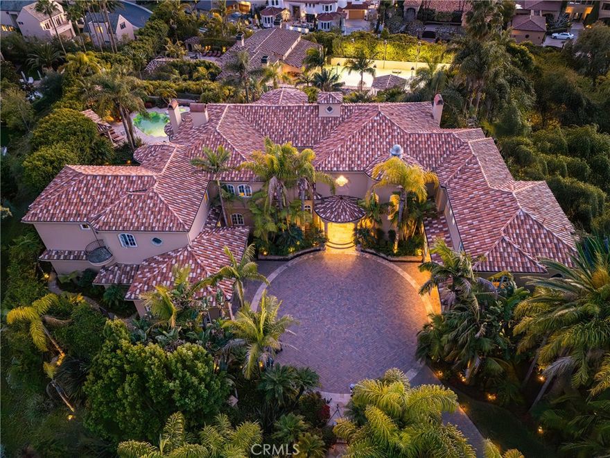 Welcome to an exquisite, one-of-a-kind Santa Barbara styled estate, positioned on the highest street within the prestigious guard-gated community of Bear Brand Ranch.

This extraordinary double-gated property spans almost 80,000 square feet showcasing two magnificent homes that epitomize luxury living and offer an unparalleled lifestyle.

The main residence provides an impressive 12,051 square feet and features seven elegantly appointed en-suite bedrooms. Upon entering, you are welcomed by soaring ceilings and large picture windows that showcase breathtaking views of the azure blue ocean. The Grand staircase gracefully ascends to an Ocean view balcony.  A separate mother-in-law suite with its own kitchen provides an oasis of privacy and comfort for guests. Wine aficionados will revel in the beautifully curated wine cellar, a true testament to the art of wine collection, while the full chef’s kitchen, adorned with exquisite marble finishes, inspires culinary creativity and artistry. Two thoughtfully placed offices—one on the main floor and another on the second—offer ample space for work and innovation, catering to both professional and personal endeavors. The ultra-large master suite serves as a serene retreat, seamlessly connected to a picturesque pool and an elegant lanai. Double 2 car garages and an expansive circular motor court further enhance the practicality and convenience of this estate. 

The second residence, affectionately known as "The Resort," encompasses 9544 square feet and is nestled on a sprawling 45,000 square foot lot, built in 2006. An entertainer’s paradise, it features a private tennis court and a chef’s kitchen equipped with dual appliances, making it ideal for hosting.    For sports enthusiasts, an indoor full basketball court awaits, alongside a fully equipped gym and even a karaoke bar and a secondary wine cellar for connoisseurs. Also a dry sauna, and a dedicated laundry room for ultimate convenience. A third floor covered California, Ocean view room is 1182 sq ft and included in the total square footage. The enchanting grotto waterfall pool creates a sanctuary for relaxation and rejuvenation. Additionally, a subterranean garage accommodating 10 vehicles underscores the exclusivity and luxury of this extraordinary estate.