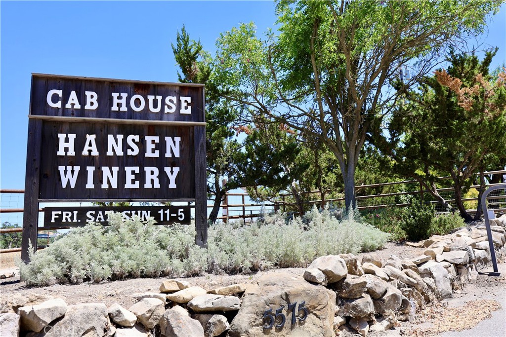 Hansen Vineyard & Winery, also known as the Cab House, located at 5575 El Pomar Dr, Templeton, CA 93465, offers an exceptional opportunity to own a premier estate winery in the heart of Paso Robles Wine Country. This 27.3-acre property features a mature, fully operational vineyard with 16.89 acres of planted vines, including renowned Cabernet Sauvignon and Cabernet Franc varietals. The winery is licensed for 5,000 cases of production and boasts an impressive inventory of wine, including approximately 11,000 gallons of Cabernet Sauvignon and 420 gallons of Cabernet Franc in barrel, as well as a library selection of approximately 2,700 cases.
Included in the sale are the established brand, all winemaking and farming equipment, and current inventory, providing a seamless transition for the new owner. The property is also home to a successful wine club with over 525 members, providing a loyal customer base and an ongoing revenue stream.
The property is equipped with top-tier infrastructure, including two Ag wells, six 2,500-gallon water storage tanks, and ample space for continued growth. The six structures on-site include a 3,000 sq ft winery building, an additional 2,200 sq ft tasting room expansion, a 3,200 sq ft warehouse, a 1,800 sq ft shop, a 1,600 sq ft equipment storage building, and a 2,400 sq ft barrel room. The property also includes a spacious 2,200 sq ft personal residence, offering breathtaking views of the vineyard and surrounding landscapes.
In addition, there is an additional building site located at the top of the property, offering the perfect location for a future personal home with panoramic views. This turnkey estate is a rare find for discerning buyers, with the potential to further expand the business and brand. With its prime location in the Paso Robles AVA, abundant amenities, and established wine production, Hansen Vineyard & Winery is the perfect setting for both winemaking and living the wine country lifestyle.