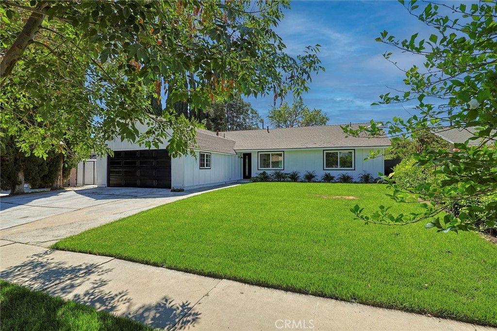 Welcome to this beautifully remodeled farm-style home, where classic charm meets modern comfort. Featuring 4 spacious bedrooms and 2 sleek, updated bathrooms, this nearly 1,600 sq ft residence offers a bright, open-concept layout ideal for comfortable living and entertaining. No detail was overlooked in this full-scale renovation. The heart of the home boasts a modernized kitchen with brand-new cabinetry, countertops, and appliances. Enjoy stylish new flooring, custom interior paint, updated lighting fixtures, and new interior doors throughout. Each bedroom is thoughtfully upgraded with new closet doors, while both bathrooms feature modern finishes, including new shower doors. Additional upgrades includes all-new dual-pane windows, new front and garage doors, new 5-ton A/C unit and updated air ducts, new furnace and replaced cleanout for the main valve, replaced plumbing in kitchen and bathrooms, newer sprinkler system and fresh landscaping, covered patio perfect for outdoor relaxation. With no expense spared, this home is completely turn-key and ready for its next family to enjoy. Whether you're hosting guests or enjoying a quiet evening in, you'll appreciate the thoughtful craftsmanship and attention to detail throughout.