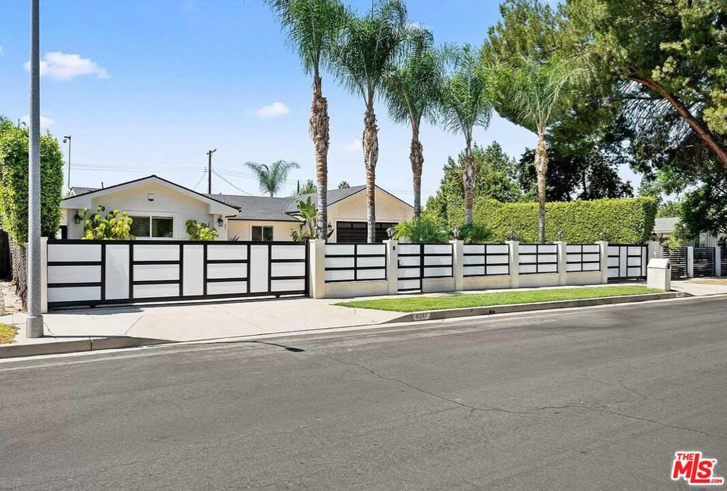 Experience luxury living in this custom-built, single-story home nestled behind private gates. Featuring a circular driveway and RV parking, this property combines convenience and style. Step inside to an expansive open floor plan with soaring ceilings and a spacious, chef-inspired kitchen equipped with a large center island, stainless steel appliances, and a seamless flow into the dining and living areas, perfect for both everyday living and entertaining. The oversized primary suite offers a walk-in closet and a spa-like bathroom complete with a soaking tub, steam shower, and sliding glass doors that open directly to the serene backyard oasis. Down the hall, you'll find three additional generously sized bedrooms. Outdoors, enjoy true California indoor-outdoor living with a stunning saltwater pool, spa, and built-in BBQ areaideal for hosting or relaxing. The low-maintenance yard features artificial turf and a drip irrigation system for the privacy trees. This smart home is fully equipped with the latest tech - new security cameras, alarm system, Ring doorbell, AquaLink pool/spa control, built-in surround sound, whole-home speakers with volume control, and a new washer and dryer.Gardener and pool service are included in the rent. Centrally located near top-rated schools, parks, shopping, dining, and easy access to both freeways and local canyons, this custom home truly has it all, in one of the area's most desirable neighborhoods. *This property is available furnished for an additional fee.*