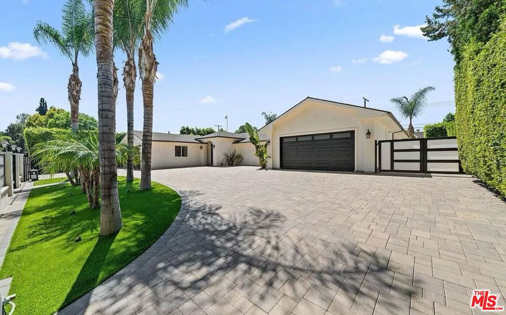 Experience luxury living in this custom-built, single-story home nestled behind private gates. Featuring a circular driveway and RV parking, this property combines convenience and style. Step inside to an expansive open floor plan with soaring ceilings and a spacious, chef-inspired kitchen equipped with a large center island, stainless steel appliances, and a seamless flow into the dining and living areas, perfect for both everyday living and entertaining. The oversized primary suite offers a walk-in closet and a spa-like bathroom complete with a soaking tub, steam shower, and sliding glass doors that open directly to the serene backyard oasis. Down the hall, you'll find three additional generously sized bedrooms. Outdoors, enjoy true California indoor-outdoor living with a stunning saltwater pool, spa, and built-in BBQ area, ideal for hosting or relaxing. The low-maintenance yard features artificial turf and a drip irrigation system for the privacy trees. This smart home is fully equipped with the latest tech - new security cameras, alarm system, Ring doorbell, AquaLink pool/spa control, built-in surround sound, whole-home speakers with volume control, and a new washer and dryer. Centrally located near top-rated schools, parks, shopping, dining, and easy access to both freeways and local canyons, this custom home truly has it all, in one of the area's most desirable neighborhoods. *This property is available furnished for an additional fee.* Available short-term or furnished.