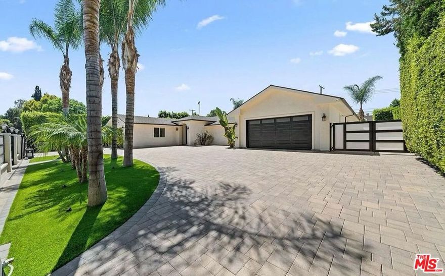 Experience luxury living in this custom-built, single-story home nestled behind private gates. Featuring a circular driveway and RV parking, this property combines convenience and style. Step inside to an expansive open floor plan with soaring ceilings and a spacious, chef-inspired kitchen equipped with a large center island, stainless steel appliances, and a seamless flow into the dining and living areas, perfect for both everyday living and entertaining. The oversized primary suite offers a walk-in closet and a spa-like bathroom complete with a soaking tub, steam shower, and sliding glass doors that open directly to the serene backyard oasis. Down the hall, you'll find three additional generously sized bedrooms. Outdoors, enjoy true California indoor-outdoor living with a stunning saltwater pool, spa, and built-in BBQ area, ideal for hosting or relaxing. The low-maintenance yard features artificial turf and a drip irrigation system for the privacy trees. This smart home is fully equipped with the latest tech - new security cameras, alarm system, Ring doorbell, AquaLink pool/spa control, built-in surround sound, whole-home speakers with volume control, and a new washer and dryer. Centrally located near top-rated schools, parks, shopping, dining, and easy access to both freeways and local canyons, this custom home truly has it all, in one of the area's most desirable neighborhoods. *This property is available furnished for an additional fee.* Available short-term or furnished.