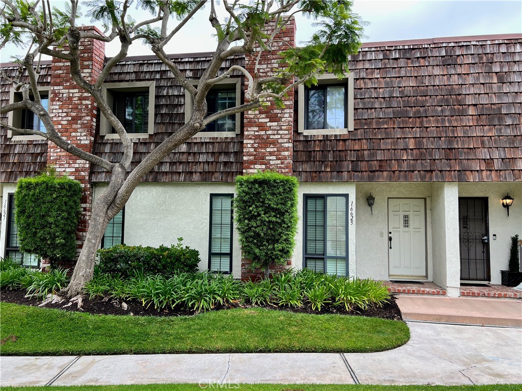 Lovely townhome in a quiet, serene setting. This Huntington Beach charmer has what you are looking for. This home has 2 bedrooms upstairs, each with its own private bath. The primary bedroom has a walk-in closet suitable for couples. Downstairs has a comfortable living room with brick fireplace, perfect for relaxing. Kitchen is dated, yet offers all of the modern appliances such as dishwasher, microwave, and a newer range. A third bathroom on the main level adds convenience and functionality. A dining area rounds out the main level rooms. The garage provides a safe covered area to park one vehicle. An enclosed patio seamlessly links the home to the detached garage, creating an all-season entertaining space. With its great layout and location, this townhome is a blank canvas-perfect for those who want to create their own stylish and welcoming space.