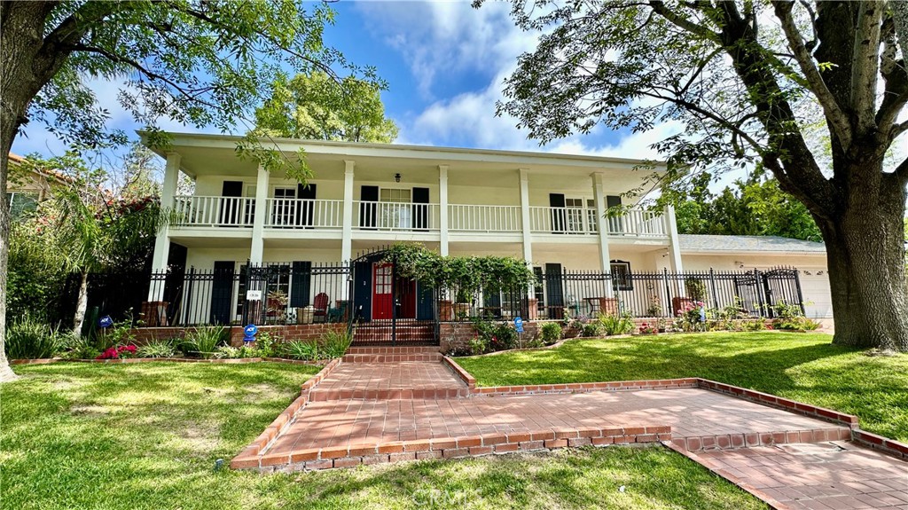 PRICE IMPROVEMENT: Welcome to the home you've been waiting for — a beautifully upgraded 4 bedroom, 3 bath residence that will capture your heart the moment you arrive. Nestled on an expansive 17,299 sq. ft. lot, this property offers exceptional potential, including room to add a possible ADU, pool, spa, or even more - a rare find in one of Porter Ranch’s most sought-after neighborhoods. From the stunning curb appeal and inviting front veranda - perfect for enjoying your morning coffee, to the thoughtfully updated interior and picture perfect backyard, this home truly checks every box. Boasting nearly 3,200 sq. ft. of spacious living, the interior features designer wood and tile flooring, recessed lighting, crown molding, smooth ceilings, a cozy fireplace, and a gorgeous formal dining room complete with a wet bar. A convenient home office provides a perfect space for remote work or creative pursuits. The heart of the home is the gourmet chef’s kitchen, offering a center island, granite countertops, updated cabinetry with pantry, and top-of-the-line stainless steel appliances. It opens to a generous breakfast area with custom built-in buffet - ideal for everyday dining and entertaining. Upstairs, you'll find all four bedrooms, including a spacious primary suite with a walk-in closet, additional wardrobe closet, dressing area, and a beautifully remodeled en suite bath featuring dual sinks and a marble vanity. Two secondary bedrooms open onto a romantic front balcony, adding charm and character. The backyard oasis is landscaped with gardens, low-maintenance turf, a large covered patio, and ample space to build out your dream outdoor amenities - whether it's a pool, spa, BBQ center, or an ADU for guests or rental income. Located within the highly rated Beckford Charter Elementary, Nobel Middle, and Chatsworth High School zones, this home offers not only luxury, but lifestyle. Homes like this don’t hit the market often — don’t miss your chance to make it yours!