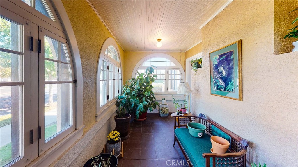 Sitting on the corner among the quaint downtown a mixture of Residences & Businesses. This amazing and unique building blends history with modern conveniences. This Mediterranean-style turn of the century home exudes timeless elegance and charm. As you approach, you'll be captivated by its striking presence, featuring a sprawling front porch adorned with lush greenery and perfect for relaxation or entertainment. Upon entry, you are welcomed into a spacious and inviting foyer with gleaming hardwood floors that extend throughout the home. The foyer serves as a central hub, connecting various areas of the residence and providing a glimpse of the beautiful staircase that splits going upward to the second level. Large windows grace every room, filling the interiors with an abundance of natural light. Ascending the stunning staircase, you'll discover five spacious bedrooms, each with its unique character. Two of these bedrooms share Jack-and-Jill bathrooms, adding convenience and style. Downstairs you will find a primary bedroom suite area that could be used as 2 bedrooms, a spacious living room with fireplace, dining room, reading room and more! A small detached studio with a full bathroom offers endless possibilities, whether it's used as a guest suite, art studio, office or home gym. The pull-through garage provides ample space for your vehicles and doubles as a versatile workspace for hobbies or projects. The south side of the property is a huge open space with plenty of room to add pool/shop parking, maybe additional dwellings or a nicely landscaped backyard. With corner and alley access, as well as 2 entries, you have many options with this property. Which one is right for you? Lot size, Sq ft, and Year built all taken from county records, buyer to verify all information to satisfaction. It's zoning allows for several different scenarios & has been used for several. The buyer should check with the city regarding their specific need if they have questions