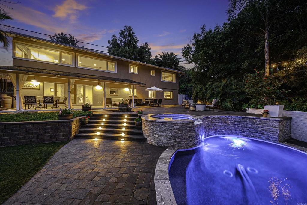 Perched in the hills of Mt. Helix with stunning mountain and sunset views, this home offers the perfect blend of luxury, comfort, privacy, and flexibility. About 750 sq ft of this 3,348 sq ft home can be sectioned off as a junior ADU or Airbnb rental with private outdoor entrance. This home features a sprawling amount of indoor and outdoor space to peacefully enjoy. Main level features luxury kitchen complete with Italian Calacatta marble countertops, stainless steel appliances, chef's island, entertainer's dream double ovens and gas range, and 48" built-in fridge. The cozy 3-sided stacked stone fireplace is a showstopper, wrapping around from the kitchen to the living room where you will enjoy gorgeous westerly sunset views. The main level features a primary bedroom with en-suite bathroom and a large walk-in closet, as well as 2 additional bedrooms and another full bath. Downstairs has its own living room and kitchenette, plus 2 more bedrooms and a full bath which makes it easy for multigenerational living, or generate rental income with the junior ADU. In addition to the attached 2-car garage, there is a laundry/utility room perfect for a home gym, storage, or office. Built in 2021, the luxury heated saltwater pool and spa features 2 waterfall spillovers, baja step with mother of pearl glass tile, luna marble coping, and color changing app-controlled lights. The backyard is your own private paradise with fruit trees, palm trees, lush landscaping and 2 grassy areas to play or picnic. This home is incredibly private, yet close to shopping, freeways, and only 15 minutes from downtown San Diego. Walk to farmers markets and dining in quaint La Mesa Village. Award-winning Murdock Elementary boundaries. 22-panel Tesla solar PPA. Check out the 3D virtual tour and schedule a showing to see it for yourself!