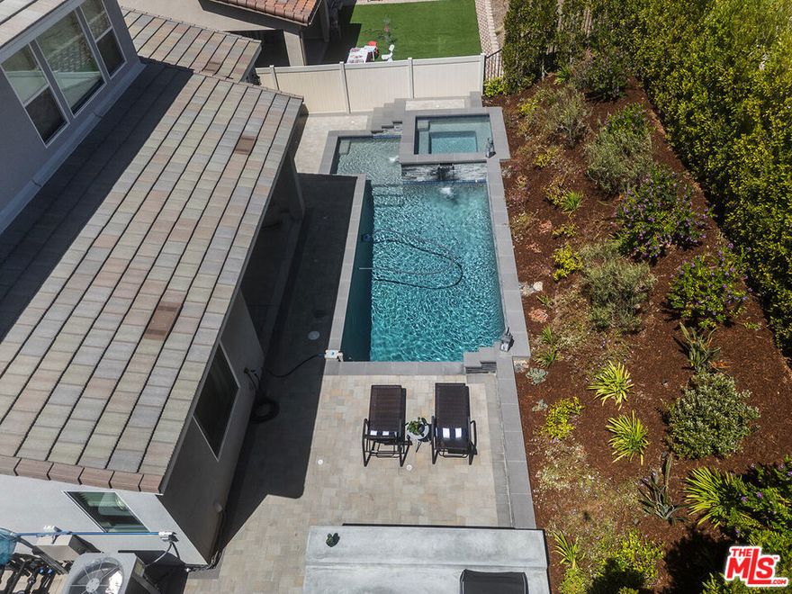 $25,000 Seller Credit for this Luxury Living Home with a Private Pool in Santa Clarita's Highly Coveted Skyline Community. Step into this exceptional, nearly-new residence where comfort, style, and sophistication converge. Built in 2023, this is a thoughtfully designed home with high-end finishes and elegant touches throughout, a 4-bedroom home which also features a dedicated office space, a loft ideal for a sitting area, theater or additional workspace, and 2.5 bathrooms. This home also has a fire suppression sprinkler system. From the moment you arrive, soaring ceilings and a striking iron staircase with a rich brown oak banister set the tone for the home's refined aesthetic. The first floor boasts a luxurious primary suite complete with a spacious walk-in closet and a spa-like ensuite bathroom, offering a tranquil retreat from the everyday. At the heart of the home lies a beautifully crafted kitchen featuring stainless steel appliances, sleek dark brown shaker cabinets, gleaming quartz countertops, a generous walk-in pantry, and an expansive island perfect for gathering and entertaining with ease. The open-concept great room invites connection and comfort, with custom built-in cabinetry and bar shelving, a sophisticated dining area, and a spacious family room designed for both relaxed living and memorable hosting. From the great room or directly from the primary suite, step outside to your own private backyard oasis. Designed with serenity in mind, this Zen-inspired retreat features a custom pool, rejuvenating hot tub, a built-in outdoor kitchen and lush landscaping that provides the ultimate in privacy and relaxation. A stylish powder room with custom tilework completes the downstairs, while the upper level offers a versatile loft, three additional guest bedrooms, and a full bathroom ideal for family, guests, or flexible living needs. This home is also a model of energy efficiency, equipped with OWNED SOLAR, ensuring sustainable living without compromise. As a resident of Skyline, you'll enjoy access to resort-style amenities including sparkling community pools, a fitness center, scenic paseos, and more. Discover elevated living in Santa Clarita where thoughtful design, modern comforts, and luxury amenities create the perfect place to call home. Seller is offering a $25K credit with offer of full asking price.