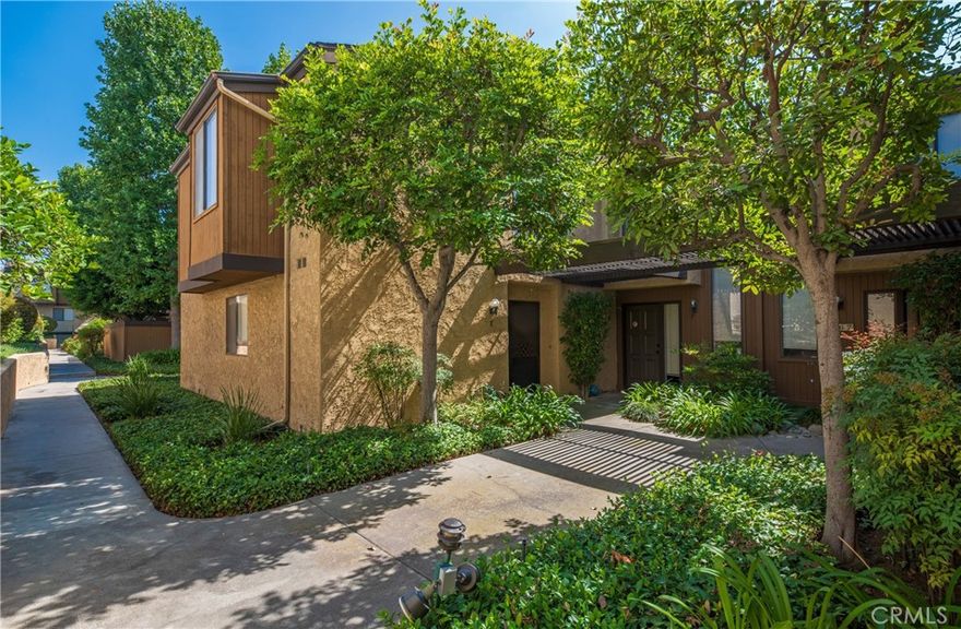 This two-story condominium, nestled within a desirable gated complex boasting lush, meticulously maintained grounds, presents an exceptional opportunity. Awaiting your personal vision, this cosmetic fixer offers a spacious and functional layout. The main level features a generously sized living room anchored by a fireplace, with a sliding door providing access to a private patio—ideal for relaxed outdoor enjoyment. The adjacent kitchen offers ample cabinetry and flows seamlessly into a dedicated dining area. Practical amenities on this level include a laundry area and a convenient powder room. The second level is dedicated to rest and privacy, housing two complete bedroom suites. Comfort is ensured year-round with central air and heat. Additional features include a detached two-car garage. Residents of this complex benefit from a sparkling swimming pool and the peace of mind offered by the secure, gated environment. The location offers convenience, situated just a short distance from the vibrant shops and restaurants of Old Town Monrovia, the local Library, a park, and a grocery store.