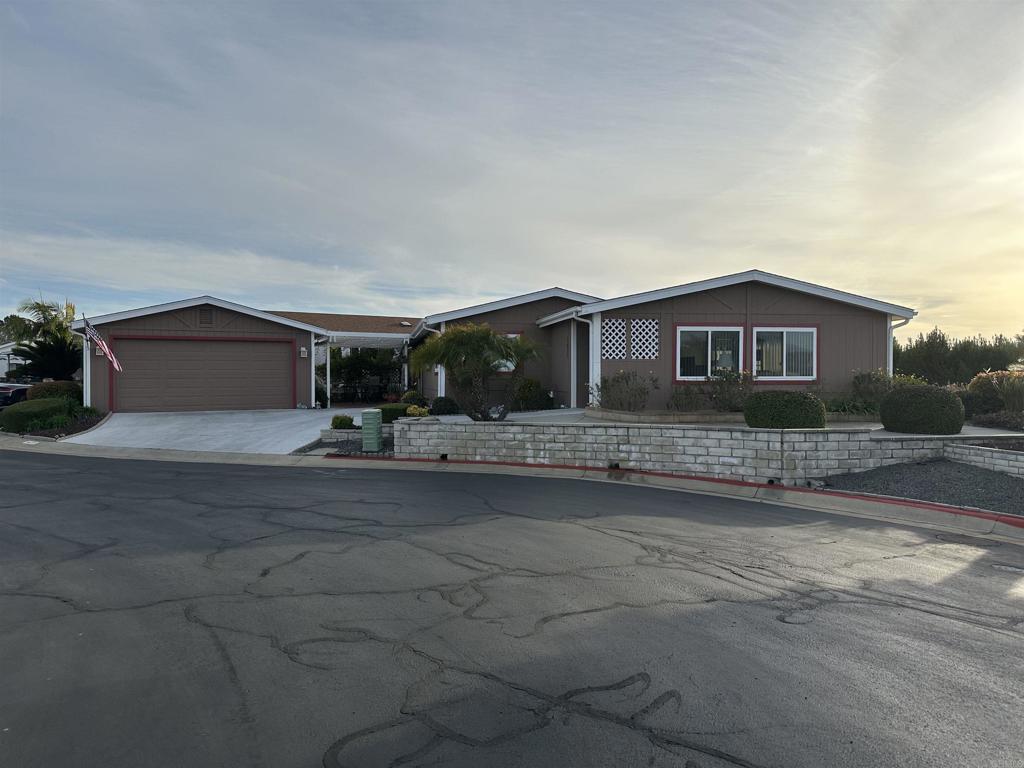 Enjoy the amazing views of the hills in this 2 bedroom, 2 bath home with over 1,900 square feet of living area. This home is in a great location at the end of a cul de sac with panoramic unobstructed views, great privacy and a cool ocean breeze. Features a large living room and a large laundry room/utility room with a built in office and lots of storage cabinets. Large guest bedroom with direct access to the patio and a large master bedroom with a large bathroom. Located in beautiful Pilgrim Creek Estates, a highly desirable 55+ gated community where you own the land! Two car garage with an attic for more storage. Close to all shopping and dining and a short drive to beaches and harbor. Pilgrim Creek Estates is a beautifully landscaped community that offers many amenities including a clubhouse with a full kitchen, billiard tables, fitness center, heated pool, jacuzzi and free RV parking. Low HOA fees of $373 per month includes water, trash and sewer fees.