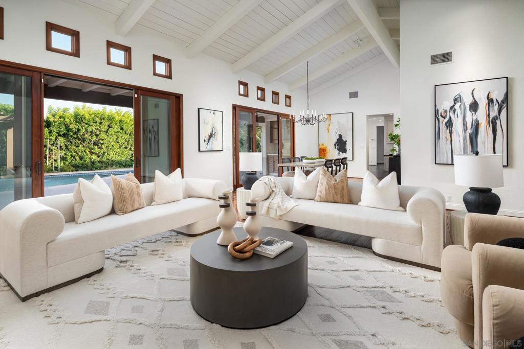 Nestled within Rancho Santa Fe’s prestigious Covenant, this single-level residence is a timeless retreat of elegance and serenity. Thoughtfully designed with classic sophistication, the home showcases sun-filled living, dining, and family rooms where vaulted ceilings and French doors blur the line between indoor comfort and outdoor serenity. Featuring four generous en-suite bedrooms, including a tranquil primary suite with garden views and a spa-like bath. A functional chef's kitchen features granite countertops, a large center island, a charming breakfast nook, white cabinetry with glass accents, and top-tier appliances. The inviting great room offers a warm fireplace, illuminated built-ins, and seamless flow through glass doors to the backyard oasis. Here, a cascading waterfall spills into the pool, complemented by a serene spa, expansive patios, and lush mature landscaping—an idyllic setting for both relaxation and entertaining. This 4,163 sq. ft. residence is sustainably powered by owned rooftop solar and includes a Social Membership to the Rancho Santa Fe Golf Club, granting access to dining, events, and the historic club lifestyle. A rare opportunity to live beautifully, privately, and connected—right in the heart of the Rancho Santa Fe Covenant.