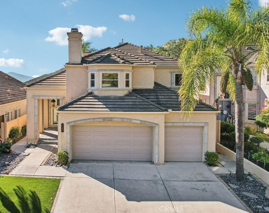 Stunning luxury residence located in the exclusive, gated community of Emerald Heights. This immaculate home has been thoughtfully upgraded with high-end finishes throughout. Upon entry, you are welcomed by warm, real wood flooring, expansive picture windows that flood the home with natural light, and striking real wood beam ceilings.

The inviting family room and kitchen feature custom-cut tile flooring, creating a cohesive and naturally elegant feel. Every room is enhanced with solid wood doors, upgraded lighting, and designer ceiling fans, reflecting the home’s exceptional craftsmanship.

Unwind in the spacious loft, complete with a stacked-stone fireplace—perfect for relaxing or enjoying a quiet evening. The primary suite boasts a beautifully remodeled spa-inspired bathroom featuring a large walk-in shower and an impressive walk-in closet.

The gourmet kitchen is appointed with rich wood cabinetry, a massive built-in refrigerator, and thick granite countertops—ideal for both entertaining and everyday living. Step outside to the outdoor BBQ area and take in breathtaking panoramic views that feel endless. Low-maintenance turf and lush tropical landscaping make the backyard both beautiful and effortless.  Lets not forget there is plenty of room for all your toys in the built out 3 car garage.

Emerald Heights offers 24/7 guarded security and resort-style amenities including parks, playgrounds, an Olympic-style pool, spa, fitness center, and more. This one-of-a-kind home is a true gem and a rare opportunity in an exceptional community.