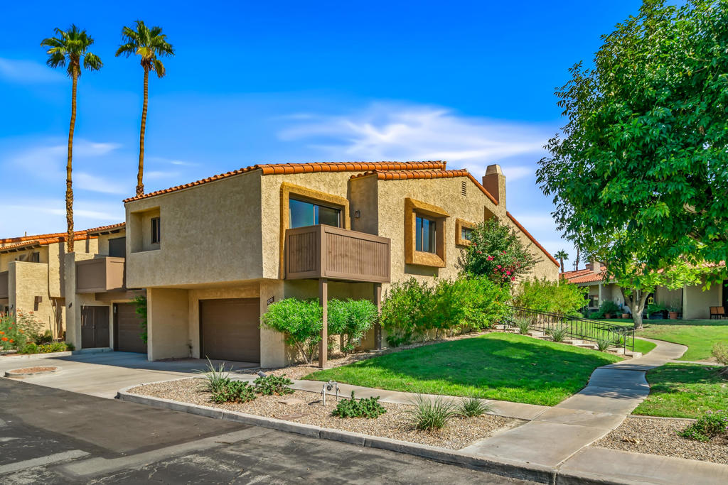 Nestled in the intimate and charming fee simple (you own the land) gated community of Sundial, centrally located near all conveniences of downtown Palm Springs (airport a block away, restaurants, city dog park, grocery shops, theatres...), sits this lovely end unit multi-level condo offering 2 bedrooms (spacious primary with large walk-in closet), 2 baths ( ensuite for primary) plus a flex room (could be used as an office, den or could easily be closed off and used as a 3rd bedroom) and an attached two car garage with plenty of storage space. The inviting and spacious (nearly 1400 sq.ft) open floor plan is filled with beautiful natural light in all rooms, vaulted ceilings & a large atrium. Enjoy the numerous cosmetic updates such as quartz slab countertops in kitchen & baths, timeless subway tile backsplash and shower, reglazed bathtub, laminate floors in main living area, modern floor tile in all baths, repainted throughout (no popcorn ceiling) & a towering, tiled fireplace in the main living space. Enjoy additional peace of mind and savings with a newer HVAC system, newer water heater, newer appliances including washer/dryer and a huge fully owned solar system (2021 with 28 panels) for maximum savings on electricity. Outdoors await an oversized covered patio with a view of one of the community pools as well as a balcony (redone in 2023) from the primary suite with spectacular mountain vistas. Looking for an easy move-in and even more value, this condo comes furnished as presented (partially furnished with many of the major pieces already there) including two large screen televisions. Sundial offers manicured grounds, a clubhouse, tennis/pickleball courts and 4 sparkling pools & spas ...this is one not to be missed!