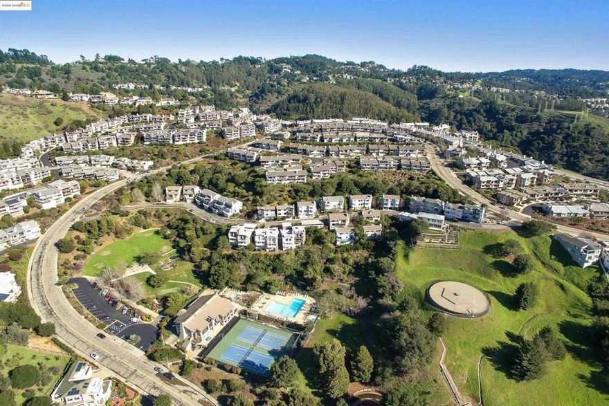 Welcome to this striking hillside sanctuary tucked within an exclusive, private Oakland Hills community, 2+ bedroom, 2.5 bath townhome with an open loft. Perched above the city with unforgettable Bay and skyline views, this home invites you into a world of elegance, light, and elevated living. The beautifully updated kitchen opens seamlessly to the dining room and expands into a dramatic, view-filled living room with an effortless flow designed for memorable gatherings and inspired everyday moments. Modern, refreshed bathrooms and serene, spacious bedrooms elevate comfort at every turn, while the tranquil primary suite offers a luxurious retreat framed by the hills. Experience the magic of the Bay from the deck sunrises, sunsets, and sparkling city lights that feel close enough to touch.