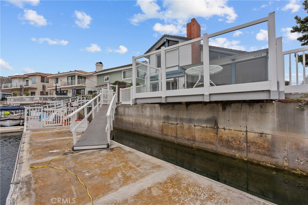 Freshly repainted and move-in ready, this waterfront gem in Oxnard’s coveted Channel Islands—perfectly situated between Malibu and Santa Barbara—offers the ultimate harbor lifestyle. Set on one of the largest lots in the neighborhood with desirable southern exposure, this 3-bedroom, 3.5-bath home spans 2,929 sq ft and boasts an open, well-designed floor plan. The step-down living room features high ceilings, a fireplace, wet bar, and floor-to-ceiling windows framing serene water views, while the dining room and downstairs bedroom open to a private atrium. The family room leads to a side yard with above-ground spa, and the dream kitchen offers classic white tile counters, a breakfast bar, abundant pantry space, and generous storage. Brand new carpet and luxury vinyl plank wood-look flooring enhance the home’s fresh, inviting feel. Upstairs, two spacious suites—the master bedroom and a large family room—provide comfort and privacy, with the master showcasing an amazing water view, spacious standing shower, and a large walk-in closet with built-ins. Outside, enjoy a deck and concrete patio that lead to a gated ramp and 40-ft boat dock—perfect for entertaining or setting out on the water. The oversized 2-car garage includes a workstation, built-in cabinets, and sliding-door storage for all your toys and tools. With easy access to beaches, marinas, dining, and shopping, this home delivers year-round living in one of the Central Coast’s most sought-after waterfront communities.