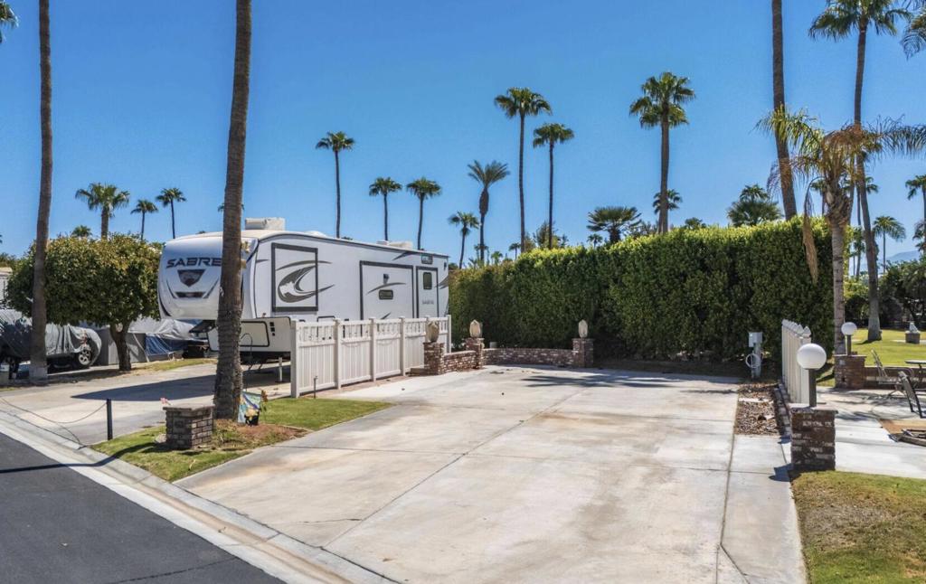 OT ONLY. Located near the La Palma Clubhouse and resort entry/exit, this lot offers unparalleled convenience. With mature hedging to the rear for added privacy, this lot has been extended to provide ample outdoor living space. Outdoor Resorts Palm Springs is a guard gated resort that sits on 137 beautifully landscaped acres with 27 holes of executive golf, 10 tennis courts, 13 pickleball courts, 8 swimming pools, a fully equipped fitness center, beauty salon/barber shop, full-service restaurant, convenience store, two club houses, activities, special events and so much more.