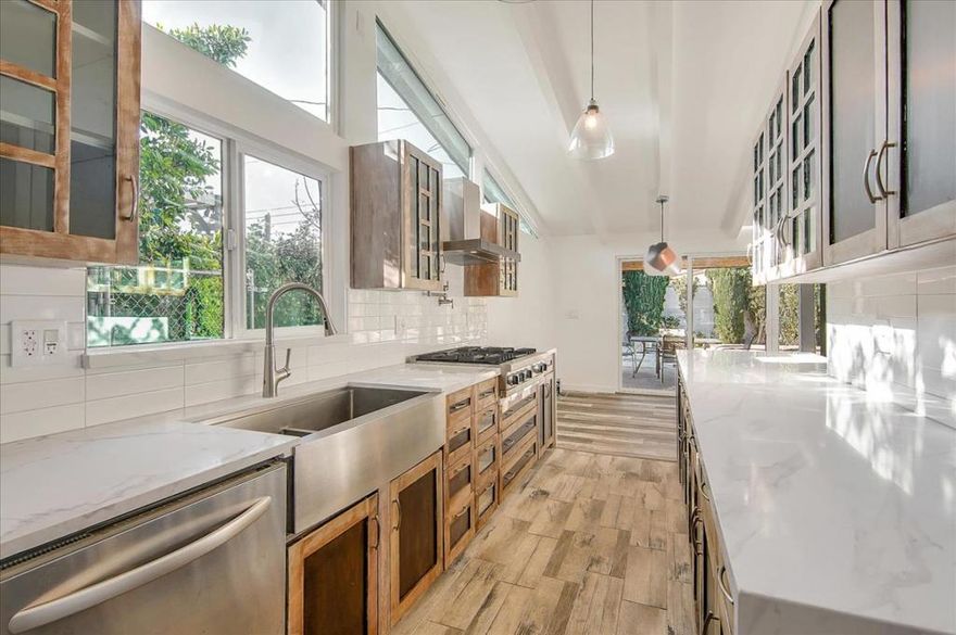 Come check out this thoughtfully designed home with 5 bedrooms, 3 baths, and a next-gen suite ideally located in Woodland Hills, ready for your love!  This newly renovated modern stunner features luxe finishes and upgrades perfect for a family who loves entertaining! The brand-new, never used, upgraded kitchen features white marble countertops that beautifully complement the organic wood tones of the cabinets. Heaps of natural light graze through your space, making it feel fresh and vibrant while highlighting the bright wooden beam ceilings!  Pop open a bottle of wine from your wine fridge and step outside to a large backyard complete with a built-in BBQ, fireplace, and a sparkling pool/spa!  Convenient features include centralized air conditioning, heat, and a thermostat, as well as in-unit laundry facilities. It has four carport parking spaces for cars and automatic sprinklers on the lawn to keep your grass green year-round!  This home is conveniently located 2 minutes away from the Victory + Tampa Shopping Center and 5 minutes away from the 101 Freeway. Very spacious ADU is included in rent and comes with its own living/family room!