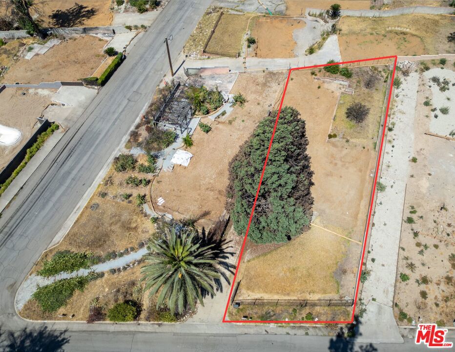 Build Your Dream in Altadena with Views & Vision! Here is your opportunity to be part of Altadena's comeback story. Located in a peaceful, scenic neighborhood on the storied Christmas Tree Lane and steps from the Altadena Library, this 6451 sq. ft. flat lot offers the rare chance to build new in a community rooted in resilience and charm.Formerly home to a classic 3 bed, 2 bath "Jane" house with a detached garage, the property was affected by the recent Eaton fire. Stage 1 and Stage 2 clearances have already been completed, paving the way for your architectural vision. Framed by a beautiful, mature pine tree offering shade and character, the lot enjoys tranquil mountain views and a strong community that remains vibrant and determined. This is more than a piece of land; it's an invitation to contribute to the revitalization of a dynamic enclave with deep local pride.This is a drive-by-only listing, please DO NOT WALK ON SITE. The property is being sold as-is for land value only. Buyers are responsible for conducting their own investigations into all aspects of the property, including but not limited to lot size, property lines, zoning, utilities, trees, insurance, and any environmental or permitting requirements. Prior to the fire, the home was connected to all utilities; however, it is the buyer's responsibility to verify current status, condition, and the process for utility restoration with the appropriate agencies.Whether you're a homeowner ready to build your dream residence or an investor with vision, this is your chance to shape the next chapter of Altadena.Let's bring Altadena back one home at a time.