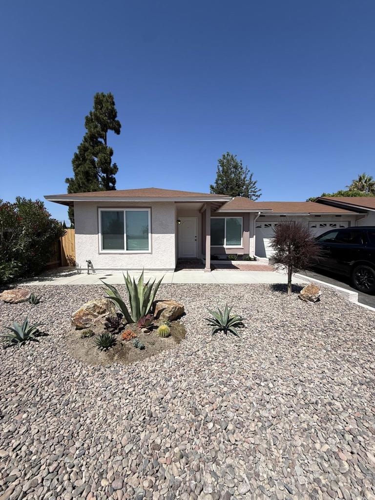 Located in the desirable 55+ senior community of Peacock Hills, this beautifully remodeled twin-home offers privacy and comfort on a generously sized lot. Enjoy low-maintenance landscaping and a spacious backyard with a large covered patio—perfect for relaxing or entertaining. Inside, enjoy an expanded and fully updated kitchen with lots of storage, new cabinetry, modern appliances (including refrigerator and stacking washer/dryer), and stylish finishes throughout. The entire home has been freshly painted inside and out, featuring new luxury vinyl plank flooring and a remodeled bathroom. Additional highlights include a new furnace and A/C, a spacious living and dining area that opens to the patio, and an attached one-car garage with an automatic opener and direct access to the home. Conveniently located near shopping, dining, and with easy access to both the 76 and 78 freeways via College or Melrose. Interested parties must view the home prior to applying via RentSpree. Primary tenant must be at least 55 and second person at least 45.
