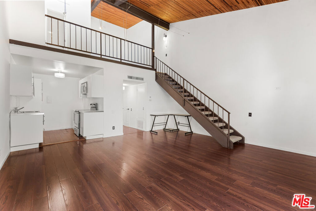 Experience contemporary comfort in this stunning 1 bedroom, 1.5-bathroom penthouse loft located in a gated resort-style community in the heart of Encino. This light-filled unit features soaring wood-slat ceilings, laminate and tile flooring, and an airy open-concept layout. The spacious upstairs loft bedroom includes an en-suite bath, vanity area, and a large walk-in closet, creating a private retreat. Downstairs, enjoy a stylish living area that flows seamlessly to an oversized balcony with tranquil views of the lush grounds perfect for relaxing or entertaining. Thoughtfully positioned on the quiet south side of the complex, this home offers peace and privacy, along with access to top-tier amenities including a pool, spa, tennis courts, gym, and rec room.Unit also includes 2-parking spaces and central air and heat.