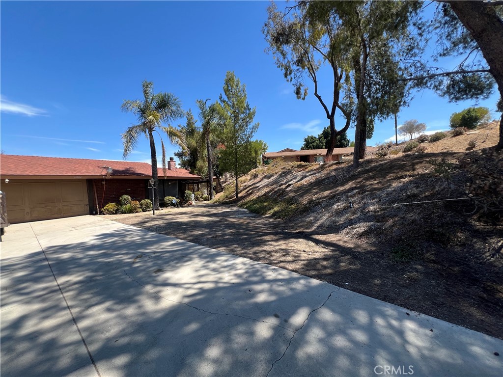 Professional photos coming soon! Welcome to 16186 Pick PL, in the highly desirable Woodcrest community in Riverside. Nestled in a serene and spacious location, this home offers stunning views of the city lights and mountain views. Perched on a sprawling 1.18 acres, this property is 2929 Bldg Sq Ft, 3 bed/2 Full bathroom, a spacious bonus room ideal for a home office or gym. This house contains 4 A/C zones, so you don't have to run the A/C in the entire home all at once. Washer and dryer are 1 yr old and 5 burner gas range with no preheat air fryer and convection oven. Remodeled kitchen and bathrooms. The inviting living and dining area includes a double-sided fireplace, creating warmth and charm. This beautiful home has two sheds, RV parking, and a new side patio with an additional patio. All have been permitted except side patio. New ducting and heater put in in 2020. Hot water circulation pump, which gives you fast hot water. Heat pump works for A/C as well. New vinyl flooring in all bedrooms and tiles in all others. New paint and new car garage door. Property comes with panels and buyer to assume lease. There are two separate panel contracts, one for $103.06 per month and the other is per KWH. The current rate is $.0256/kwh and produces anywhere from 400 kwh to 900 kwh per month. The billing may vary from $150 to $250 per month. Seller has not paid an Edison bill since May 2022 and currently has a $500 credit. Property is septic and had new leach lines in 2016. Cameras do not belong with the purchase price. So much more, a must see home!!