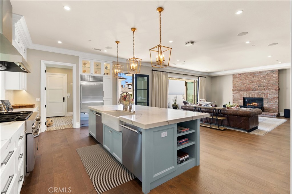 Nestled in one of Newport Heights’ most coveted enclaves, this exquisite custom home blends timeless architectural elegance with warm and contemporary charm. Meticulously crafted with an uncompromising dedication to detail, this residence captures well-appointed everyday living and effortless entertaining.
The classic façade with Bevolo gas-lit exterior lanterns, a heritage Magnolia tree and inviting front porch delivers striking curb appeal. Inside, the home unfolds effortlessy, rich natural textures, custom millwork, stone accents, and built-ins echo the principles of thoughtful modern farmhouse design while state-of-the-art systems add seamless modern functionality. Ten-foot ceilings offer a bright, airy and spacious feel, yet the home is balanced with comfortable and relaxed living.
The chef’s kitchen is outfitted with top-of-the-line Thermador and Sub-Zero appliances, 2 dishwashers, 3 ovens, an ice maker, and a 48” range. A spacious island with seating, 36” ceramic farm sink, walk-in pantry, and butler’s pantry. The kitchen flows seamlessly into the expansive great room/media lounge, where a 200” drop-down theater screen, 4K projector, and 75” wall-mounted TV create a world-class entertainment experience.
Oversized folding glass doors opening to a private backyard oasis. Enjoy nights around the built-in fire pit or relax in the pool or spa, this yard is designed for year-round enjoyment.
Each of the four ensuite bedrooms is generously sized and thoughtfully appointed. The primary suite is a private sanctuary, featuring a spa-inspired bathroom, walk-in closet with custom built-in’s
Additional highlights include: Two interior gas fireplaces, Family dining area, Built-in bar and two wine refrigerators, Advanced Crestron smart home, automation, Integrated audio, lighting, climate, and security systems, Water filtration and softening systems, Dedicated laundry room, Finished garage with epoxy flooring, A/C unit, and custom racking system, Copper rain gutters and down spouts, Side yard/dog run and more.
With thoughtful design that honors tradition while embracing innovation, this home perfectly balances the aesthetics of modern farmhouse living with the comforts of cutting-edge technology.
Located just minutes from award-winning schools, Lido Marina Village, the beach, the bay, and 17th Street’s vibrant shops and restaurants , this home offers the ultimate in coastal luxury and convenience.