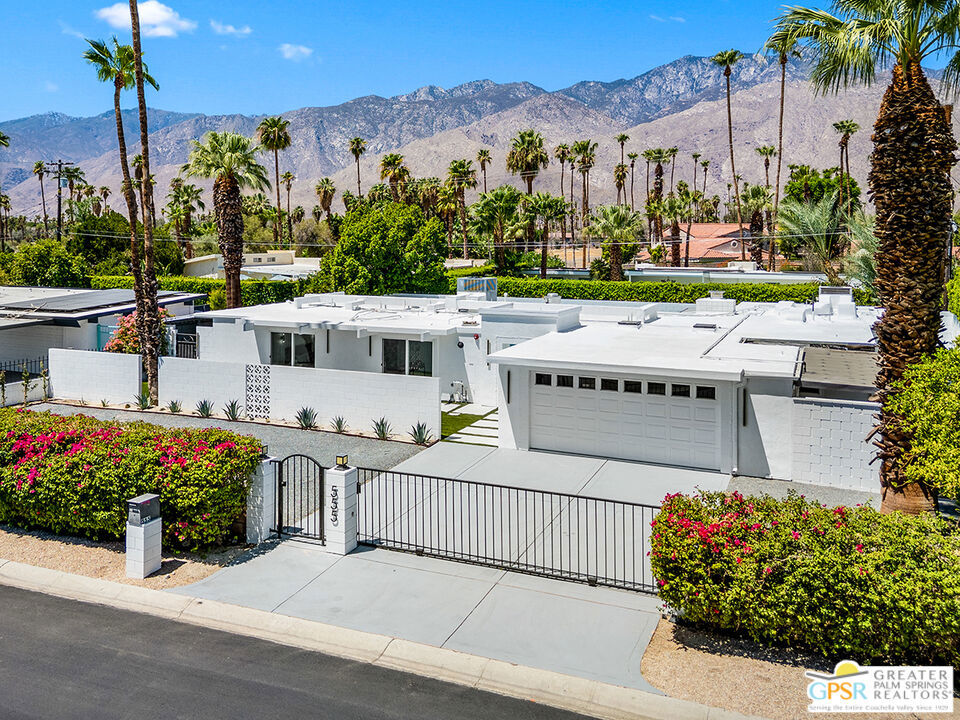 Located in the highly desirable neighborhood of Little Beverly Hills in South Palm Springs, this beautiful mid-century, Alexander-built home blends classic desert architecture with sophisticated modern updates. Completely redesigned, this home and casita feature five stylish bedrooms, four remodeled bathrooms, and contemporary tile flooring throughout the home and casita. The main house hosts four of the bedrooms, three bathrooms, an open concept kitchen with high-end appliances, and a living/dining area compete with a beautifully tiled fireplace. Blending the inside and outside living areas, a large glass sliding door and windows offer views from the living room and kitchen to the resort-style backyard complete with sparkling pool, built-in grill, and views of the San Jacinto Mountains. Accessed off the pool area or via a walkway on the north side of the property, the attached casita hosts the fifth bedroom, the fourth bathroom, a second open concept kitchen with high-end appliances, and a spacious living room with views to the pool and backyard living area. With an abundance of space and a flexible layout, this spacious home is ideal for entertaining, hosting guests, or perhaps creating a separate living area for an aging parent or relative. And Little Beverly Hills is currently under the 20% cap on short-term rental permits, so this home could possibly be used as an income generating short-term rental property. Other highlights of the property include dual pane windows throughout the home, a gated driveway, and a whole house fire suppression system. With so many wonderful features and updates, this home is not to be missed. Schedule your private showing today!