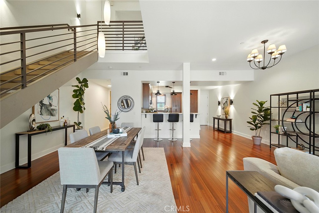 Experience sophisticated living at desirable City Place Lofts in this 2-bedroom / 1.5-bathroom residence located in the East Village Arts District. Spanning 1,770 square feet, this top-floor unit with no neighbors above, offers an additional level of security, superior views, and open-concept living allowing the flexibility to create a custom-living experience. The lower lower level features living and dining areas with 9 ½ ft. ceilings, hardwood floors, and expansive near windows allowing an abundance of natural light and showcasing downtown views. Floor-to-ceiling sliding glass doors open to a private patio, perfect for relaxing, outdoor grilling, and dining. The kitchen features timeless solid-surface countertops with a breakfast bar, attractive tile backsplash, stainless steel appliances, and elegant wood cabinetry. The first floor is completed with a laundry room equipped with a washer and dryer, and a convenient powder room. Upstairs, brand-new carpeting has been installed throughout the bedrooms and hallway, and the generously-sized primary bedroom offers ample room for a work-space, dressing area, retreat, etc. The fully permitted second bedroom has recently been reconfigured and features a brand-new closet with organizers, updated electrical, and contemporary lighting. The primary bathroom is spacious with a sunk-in tub, separate shower, dual sinks, private water closet, and plenty of cabinetry. The unit has been freshly painted throughout, has central heating and air, and includes two dedicated side-by-side parking spaces. Residents enjoy amenities such as a well-equipped fitness center, community/recreation room, lobby, several sitting areas, elevator, visitor parking and controlled entry. Located near vibrant restaurants, entertainment venues, shopping, the Long Beach Convention & Entertainment Center, and waterfront attractions including The Aquarium of the Pacific, Shoreline Village, and so much more! Experience refined urban living in this exceptional home.