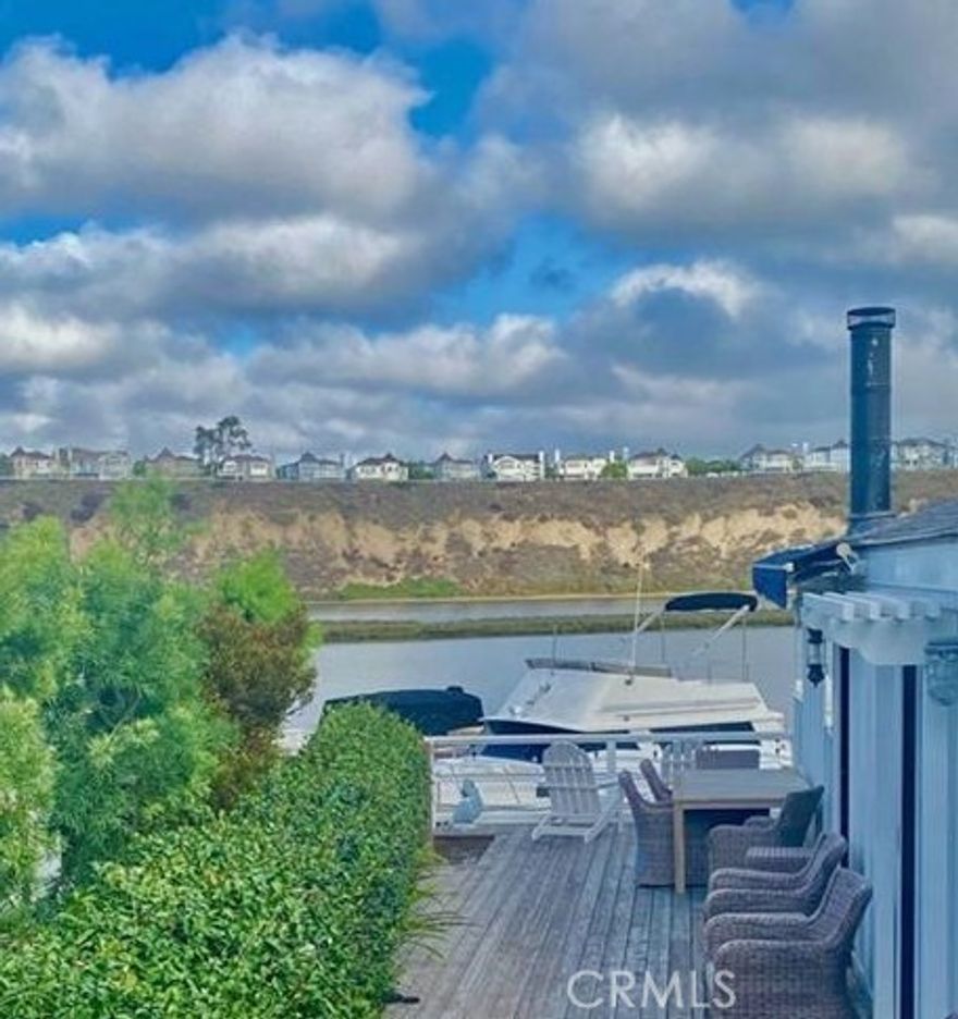 BAY VIEW home in Bayside Village in the heart of Newport Beach! Two bedroom/2 bath home is just steps to back bay, marina, private beach, club house and recreational facilities.  And just minutes to Fashion Island, Balboa Island and world class beaches.  This home has a open floor plan with added space in the living room and vaulted ceilings.  Spacious bedrooms with 2 full baths and large custom finished walk in closet in master bedroom.  Great deck off the living & dining rooms with bay views plus private side yard patio perfect for entertaining,  All updated with beautiful finishes and move in ready!! Watch the boats and paddle boarders go by while enjoying the cool ocean breezes.  Extra long carport has room for 2 cars plus golf cart and has a large storage shed.  Property is on leased land at $4700 monthly includes numerous area amenities including  2 pools/jacuzzis, private beach, 2 clubhouses with party venues, billard room, plus dog park!  There are no HOA fees.  Come live the Newport Beach vibe lifestyle at a fraction of the coast of nearby neighborhoods.
 Large private fenced patio is surrounded by mature trees and a storage shed complete the package for this great home.  Property is on leased land with at $4700 monthly includes numerous community amenities.  Enjoy all that this special community has to offer at a fraction of the price of surrounding neighborhoods.