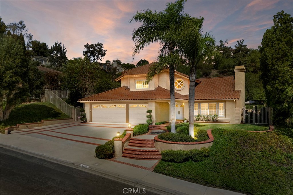 Here is a home to love and be extremely excited about. This one will take your breath away. A magnificent, covered cabana was added (nearly 500 square feet) and the entire pool area was re-done, all to match the architecture of the main home. More about that later. The curb appeal is obvious as the beautiful double door entry invites you in. It feels like a new home! Inside the crown molding enhances the ceiling lines, custom baseboards, luxury vinyl flooring cover the downstairs except for the downstairs bedroom (currently used as an office), with an adjourning bathroom remodeled with marble counters and upgraded shower. Custom plantation shutters cover the windows, the cathedral ceiling gives space to the living room and dining room. Two upgraded gas fireplaces grace the living room and the family room. An elegant granite wet bar with cabinets that match the kitchen with glass doors. The kitchen appliances are Kitchen Aid, top of the line, with double ovens, microwave, and dishwasher. Upgraded cabinets, granite countertops on the island and the kitchen counters including the backsplash. Walk in pantry that has been organized, and a ceiling fan adding to your comfort. The kitchen is open to the family room and looks out to this fabulous backyard. As you go up the staircase, notice the upgraded spindles, no detail overlooked. Enter the primary bedroom with views of the backyard. A walk-in closet organized with drawers, adjustable shelves and shoe racks is a valuable addition. To keep it cool , there is a ceiling fan. The primary bath has quartz counters and upgraded cabinets and vanity with a separate bathtub and shower completing this room. Both additional bedrooms have ceiling fans and organized closets. The Jack and Jill bathroom between these two is upgraded. Now to the unbelievable backyard: the pebble Tec pool and spa is salt water, and the pool systems include a variable speed pump, automatic pool fill, remote control for lighting , temperature, and spa. The covered cabana includes large granite island, sink, refrigerator, ceiling fans, gas fireplace, speakers, custom wood cabinets, a flat screen TV, Polk sound bar, Denon receiver, Sony DVD player and two electric heaters. There is also a built-in outdoor kitchen, with Lynx appliances including the BBQ, burner and warming drawer, a refrigerator and granite counters. This home is outstanding. It was replumbed back in 2019 and a new water heater added in 2020. Come and see!