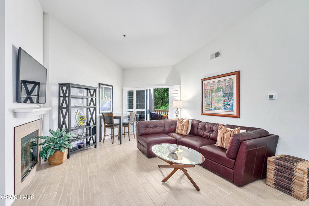 This spacious 1-story condominium, top-floor home offers over 1,100 sq. ft. of sophisticated living space. This private, rear-facing unit features gorgeous mountain and woodland views from not one, but two private balconies overlooking serene landscape and natural surroundings that make Oak Park so desirable. You enter a main living area with soaring vaulted ceilings and an abundance of natural light. The open-concept living room features a cozy fireplace and flows seamlessly into the dining area. An updated kitchen boasts newer appliances with everything a home cook needs within easy reach. All bathrooms are full-sized and the primary suite includes its own en suite bathroom, as a well-sized walk-in closet, plus a private balcony overlooking serene natural landscape. Attractive wood-like ceramic plank flooring offers great style with low maintenance. Additional conveniences include a new HVAC system plus in-unit laundry with newer washer, dryer and water heater. Shadow Ridge offers offers resort-style amenities, including a heated pool and spa, sauna, fitness center, racquetball courts, pickleball, tennis and basketball courts, a comfortable clubhouse and miles of nearby hiking trails and parkland. HOA dues include high-speed Internet, Wi-Fi, and CATV with HBO. (an estimated $200 monthly value). Top-rated Oak Park schools and Oak Park Library are just down the road, plus you're within close proximity to excellent dining, shops and services. Enjoy easy access to the 101 Freeway. Do not miss this opportunity to own an absolute turn-key, condominium home in one of Ventura County's premier communities.