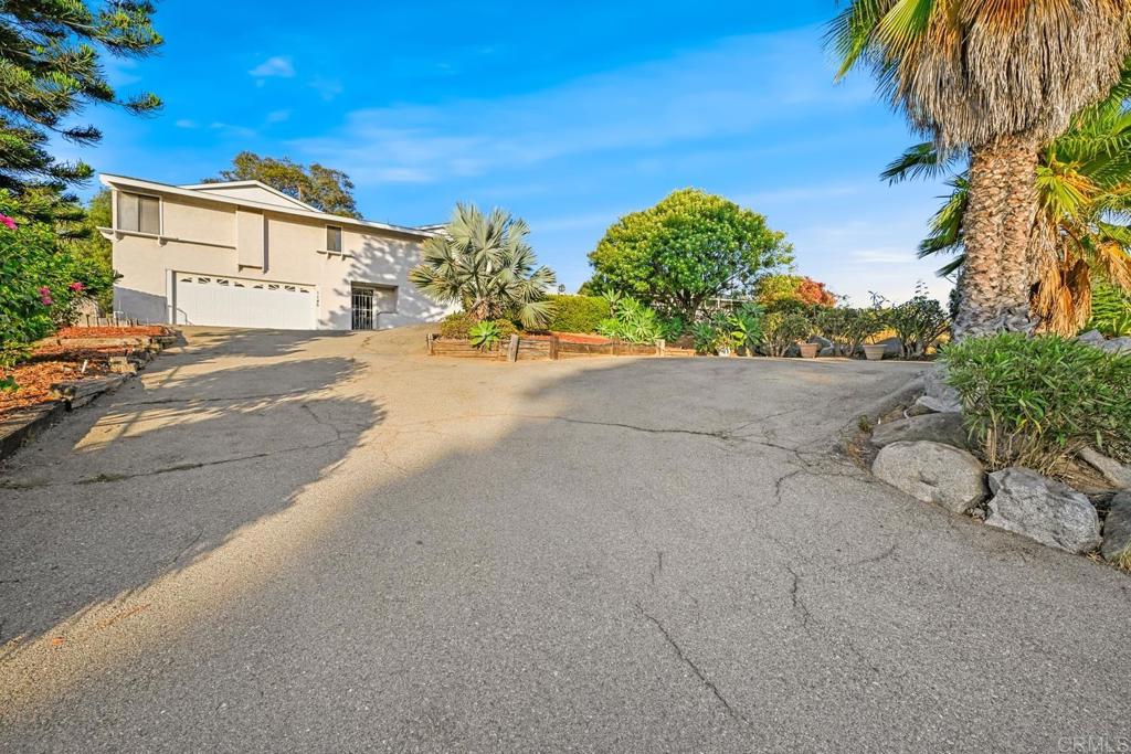 Welcome to 1145 Tower Place, a spacious 4-bedroom, 2-bath home offering 2,300 sq. ft. of living space with an attached 2-car garage in central Vista. Originally built in 1961, the home was extensively expanded and renovated from it's original size of ~900 square feet in 1997–1998, giving it the feel of a much newer residence than the original date of construction suggests. All living areas are conveniently located on the upper level, creating the ease of single-story living (steps are required to get to the main living area). The floor plan features a large family/living room with a cozy fireplace that provides warmth and ambiance, and direct access to an expansive 31’x17’ deck—perfect for entertaining or relaxing while enjoying southwest views and glimpses of the coast on clear days. The oversized dining room accommodates large gatherings, while the kitchen provides abundant cabinetry and counter space with updated appliances including a newer refrigerator, dishwasher, and oven. The primary suite is truly impressive at ~850 sq. ft., with a newer sliding door to the deck, dual-sink bath, and walk-in closet. One additional bedroom is nearby, while the other two are located on the opposite side of the home for maximum privacy. Major upgrades include a full roof replacement with skylights in 2024, newer dual-paned windows and sliders (2018–2024), modern HVAC ducting, and a rebuilt deck (2020). The home also offers a 2-car garage with added storage, two extra storage closets, and a large entry-level bonus/storage room (approx. 1-car garage size). Additional storage is found under the deck and throughout the property. The backyard is framed by beautiful native boulders, and the wide driveway provides multiple parking spaces in addition to the garage. Located on a private road off a cul-de-sac, the setting is peaceful and low-traffic yet highly convenient—just minutes to freeways, shopping, dining, and North County attractions. With its spacious layout, convenient updates, abundant storage, and central location, this home offers both comfort and lifestyle at a very affordable price point.