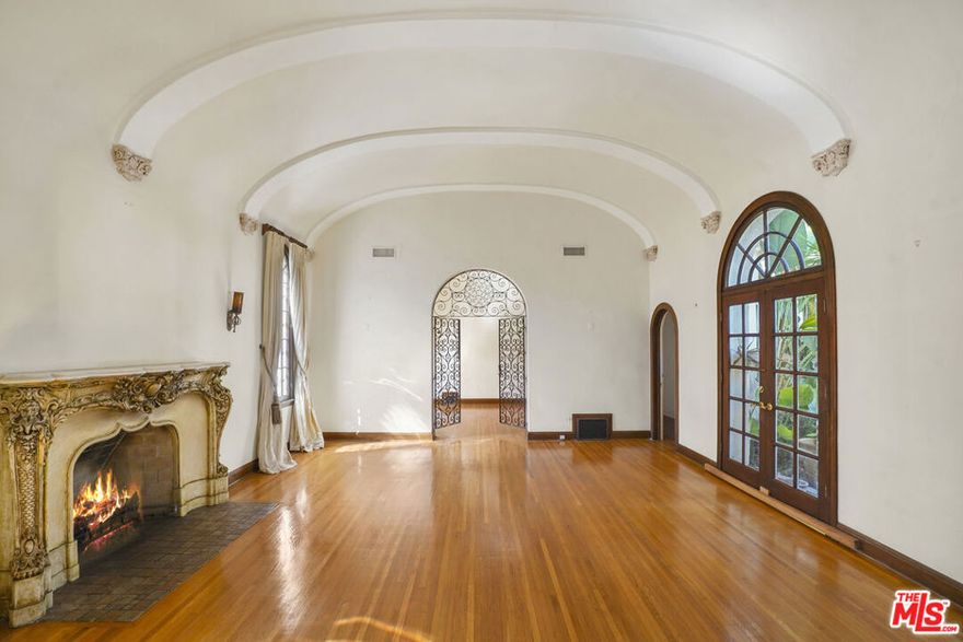 Stunning Spanish Revival home located in the heart of Hancock Park! This one of a kind property features dramatic 15ft vaulted arched ceilings, stained glass windows, intricate moldings and a marble mantle with a gas fireplace, which is decorative. The home features 3 bedrooms and 2 full baths. Set behind wrought- iron gates includes a tranquil courtyard with fountain, an abundant architectural character. A rare opportunity to restore a piece of Hollywood's golden era.